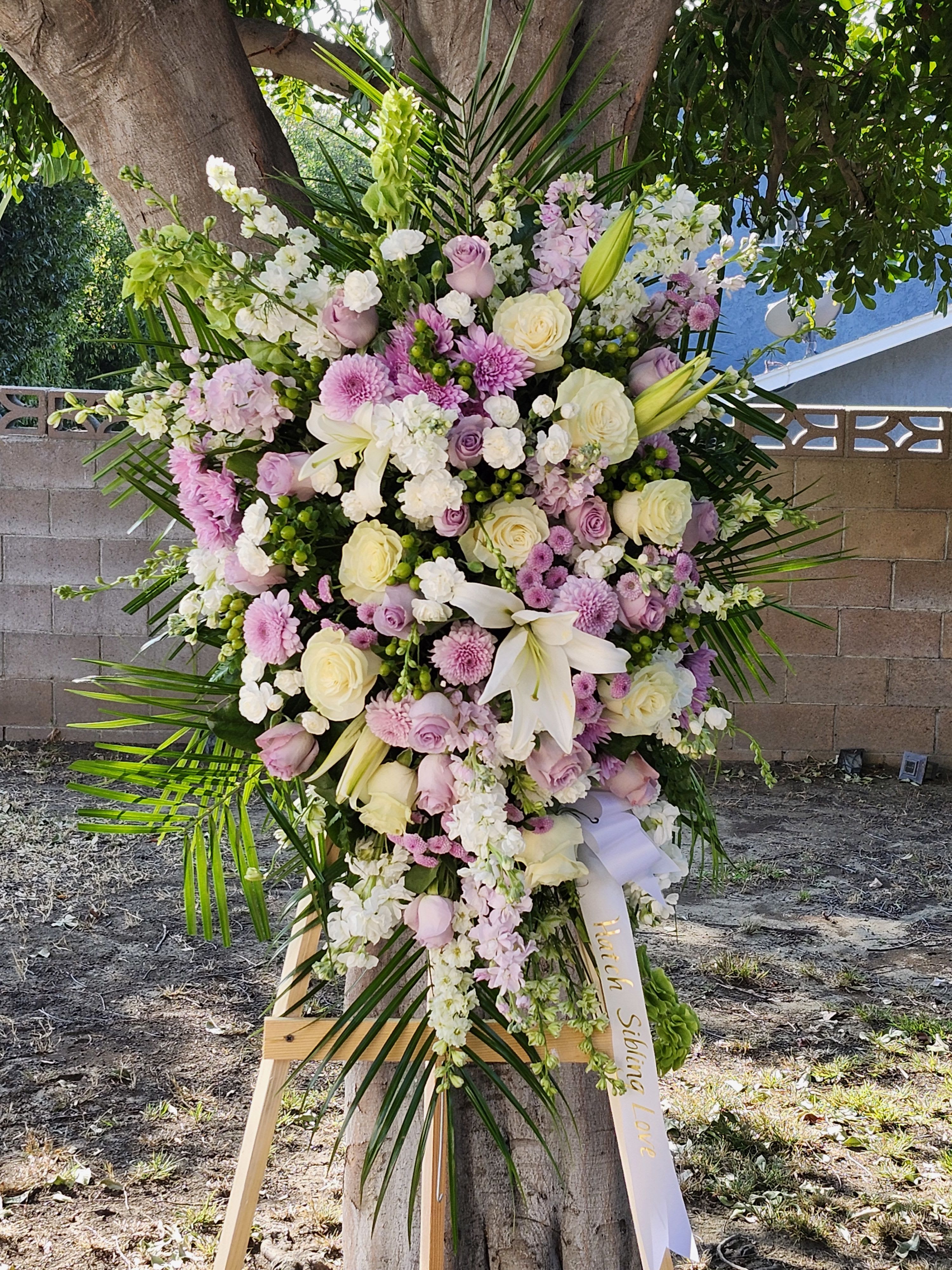 Lowell Lavender  - Lavender Funeral flower Spray arrangement filled with roses and many more beautiful flowers of lavenders and whites. May request color change or add on. Current photo is shown in deluxe size. The personalized banner can be  purchased by searching &quot;Sympathy Banner&quot; 