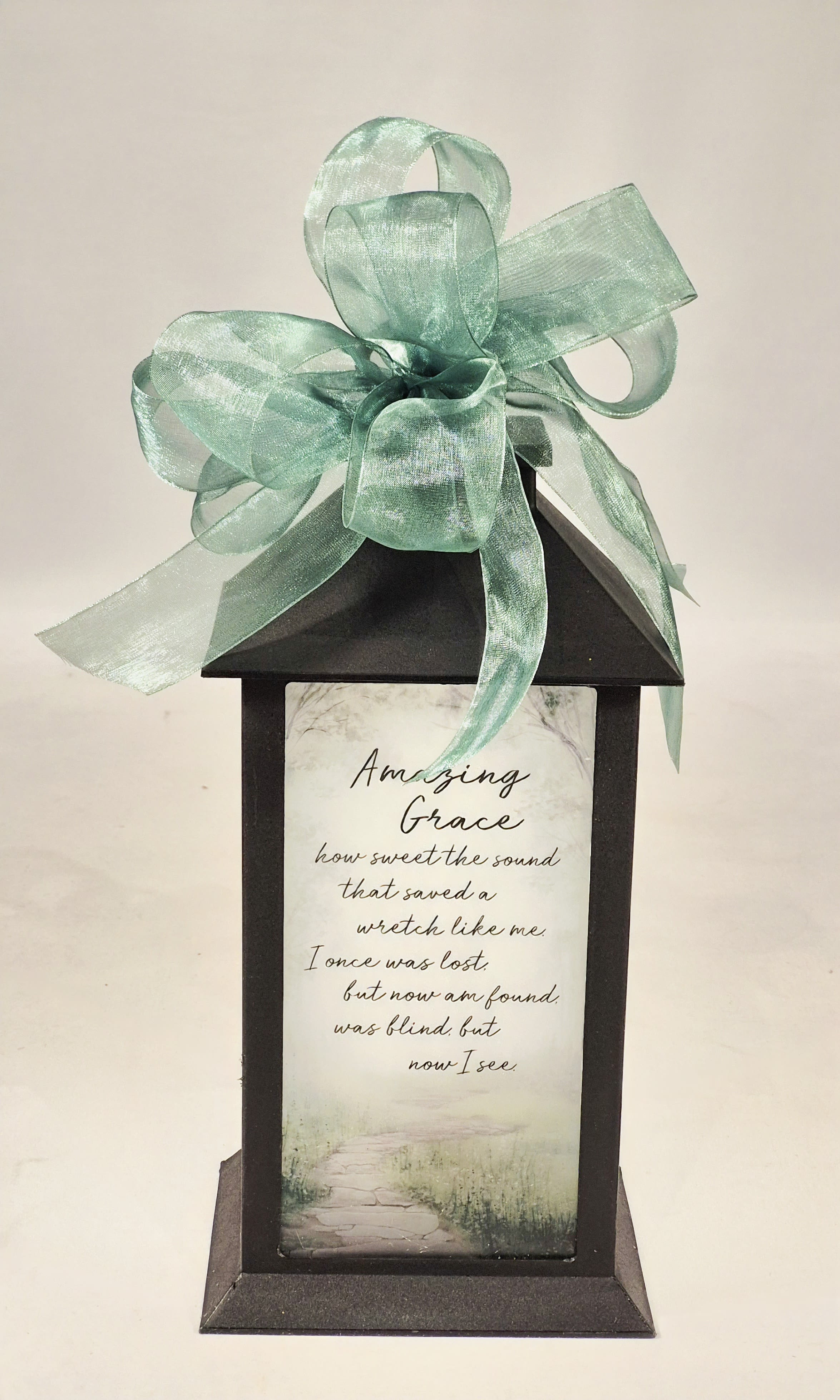 &quot;Amazing Grace&quot; Lighted Memorial Lantern - These lanterns are made of weather friendly materials and UV printed frosted glass. They include a flameless LED candle with a built-in automatic timer: 6hrs ON/18hrs OFF (3 AAA batteries are included). They are suitable for hanging or free-standing use. Beautiful gift for Sympathy, Get Well or Just Because.   W: 5.5&quot; H: 13&quot; D: 5.5&quot;