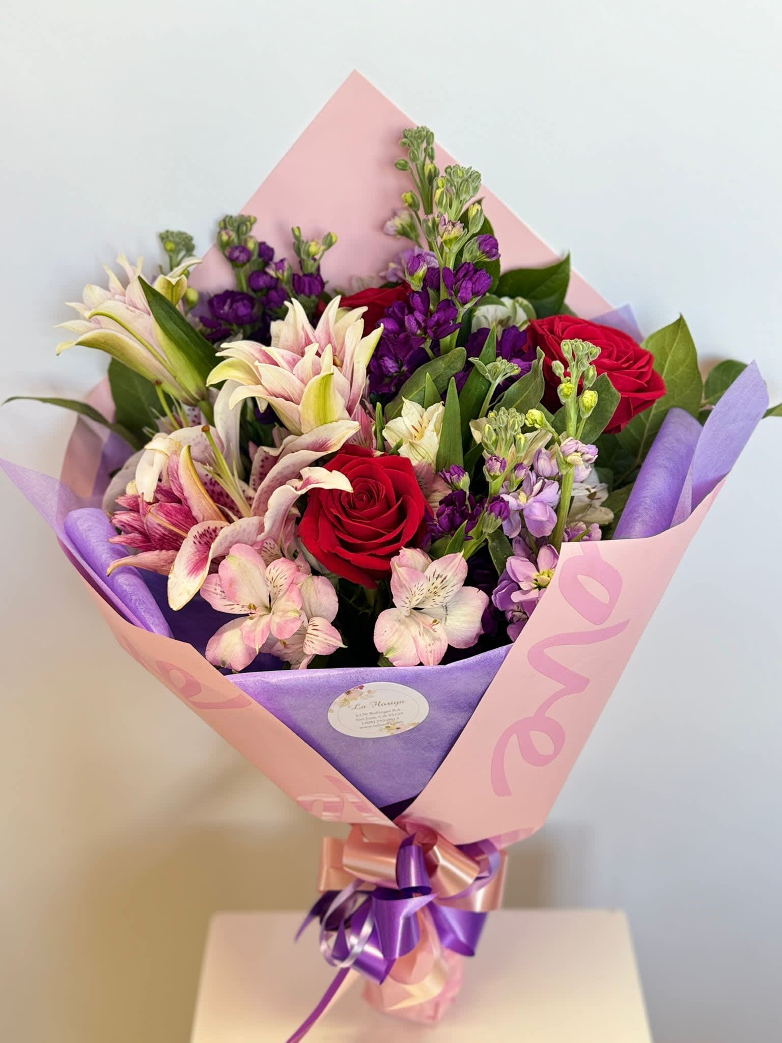 Pretty Pastels Wrapped Bouquet - Designer Choice—Our florist designer will use pastel colored seasonal flowers for a unique bouquet. Prices and availability of seasonal flowers may vary.