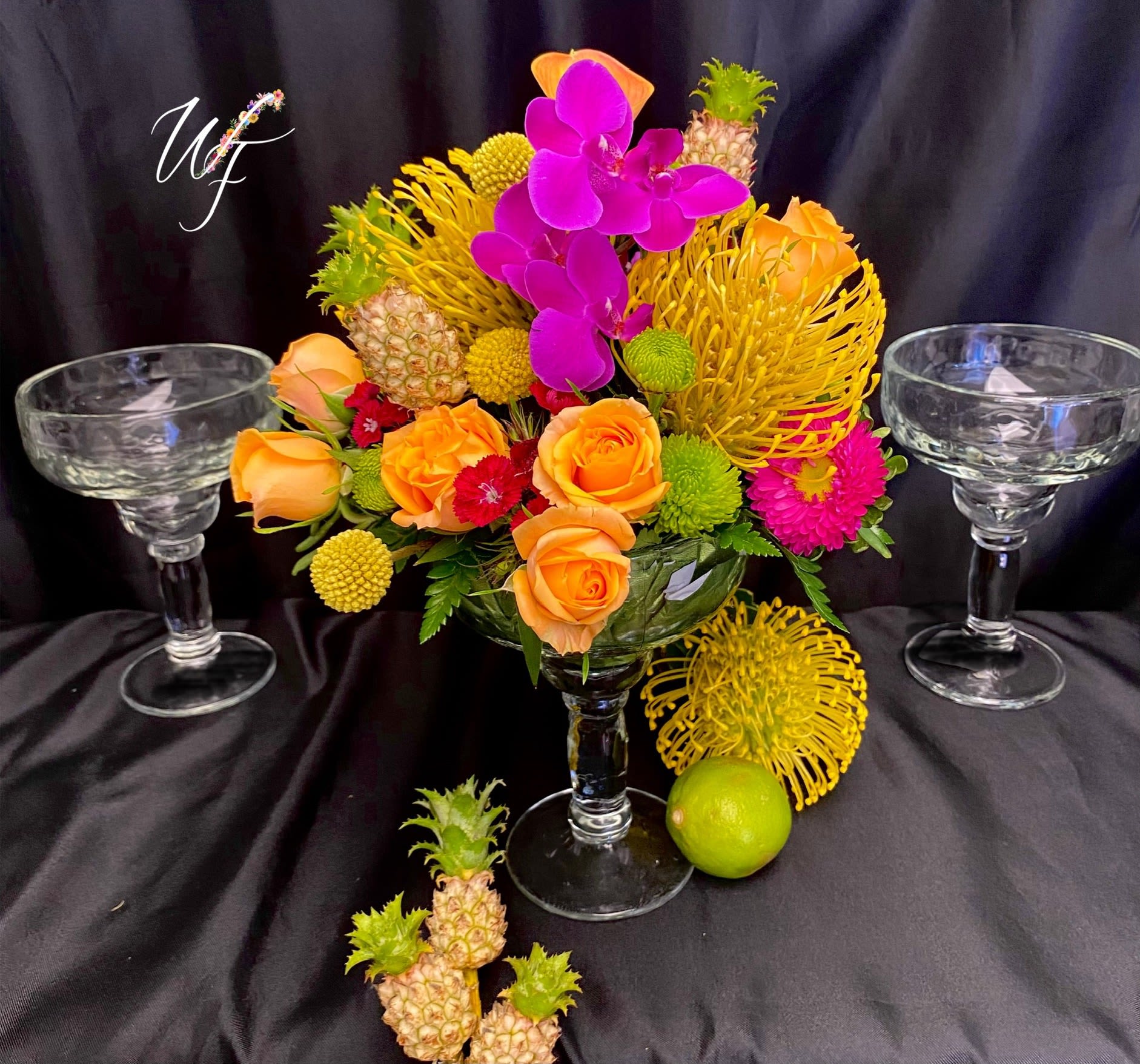 Tropical Margarita!  - **Tropicals will always vary, and for best results 1 week’s notice is highly recommended.  **Picture shown is the premium fee of $150.00 which includes 1 Margarita glass arrangement right from the tropics! 2 extra Margarita glasses along with lime and tropical accents. **Standard price- A vibrant margarita glass sure to bring the tropics to order!