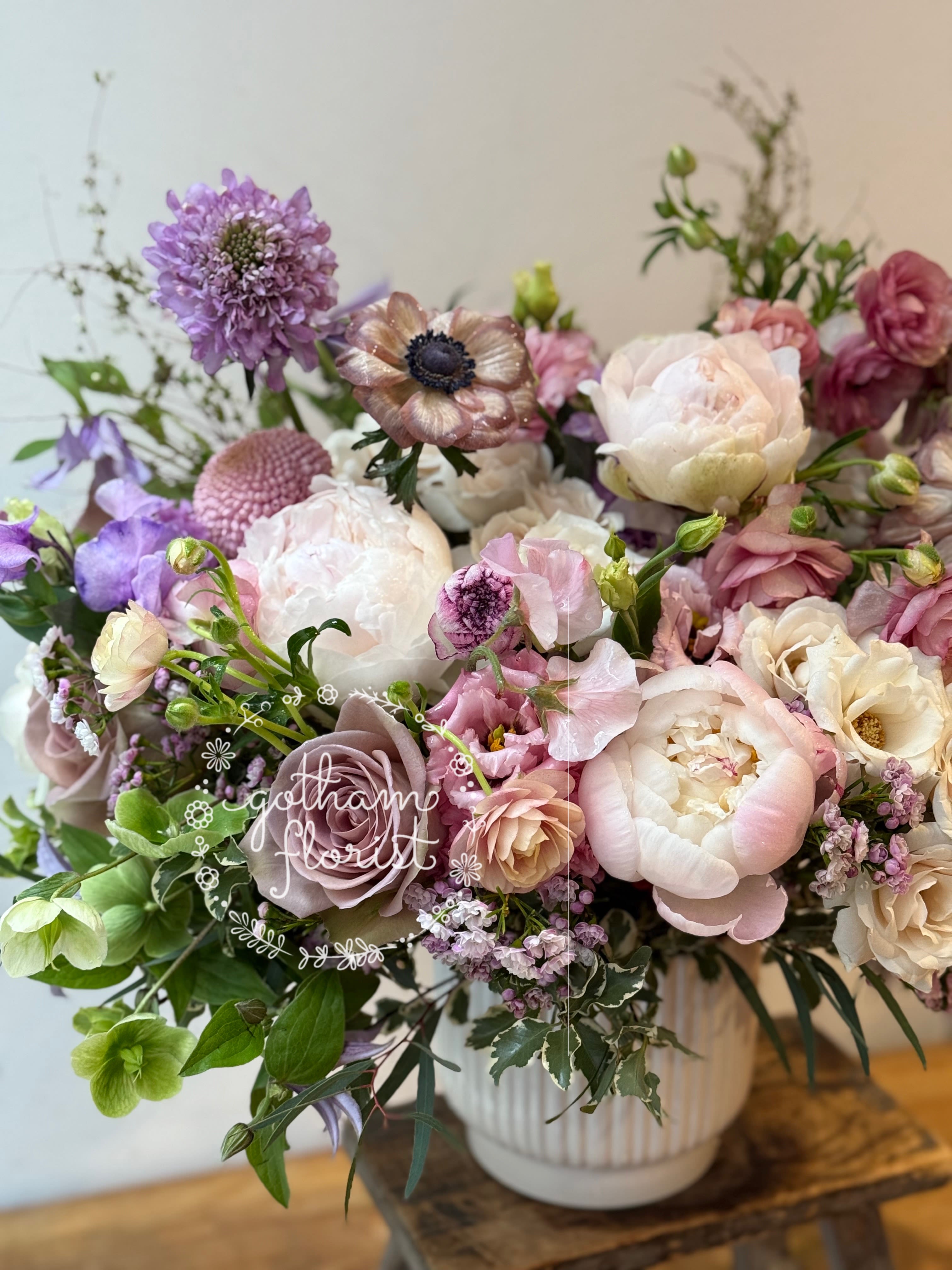 Lavender Princess - Soft lavender and purple flowers in rustic tin vase. Send unique, gorgeous flowers from the best florist in manhattan NY.