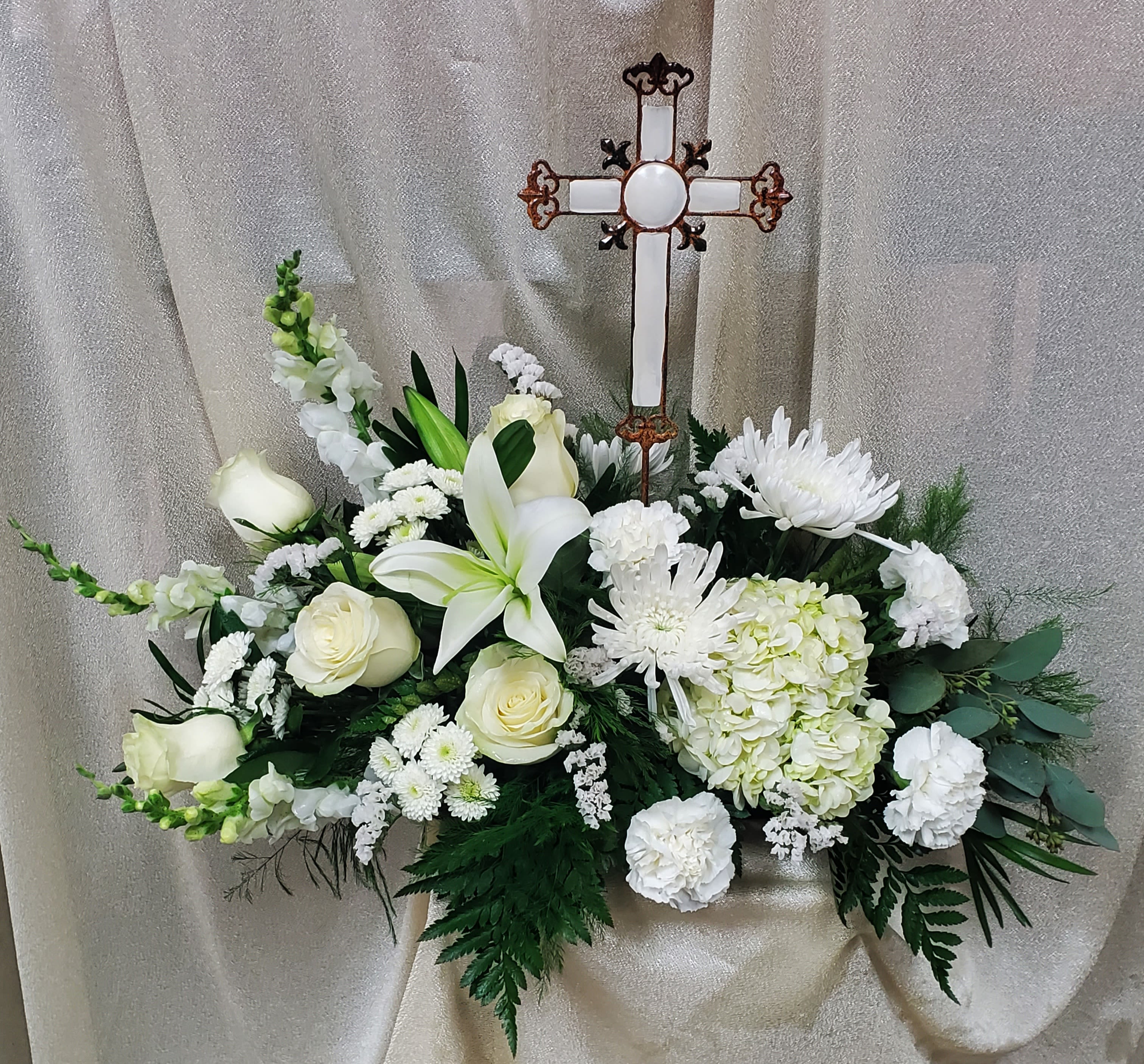 Heavenly Delight Heavenly Delight - Send to the home or a funeral sympathy arrangement to a service. All white tones arranged to accent metal cross that can be used afterwards .