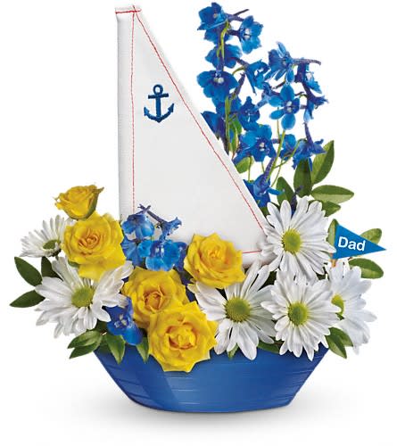 Teleflora's Captain Carefree Bouquet Teleflora's Captain Carefree Bouquet - Delight Dad with a bright arrangement of fresh flowers delivered in a charming blue sailboat. It's the perfect Father's Day gift. Includes yellow spray roses blue delphinium and white daisy spray chrysanthemums. Delivered in a Captain Carefree keepsake.Approximately 11" W x 12" H Orientation: All-Around As Shown : T13F100ADeluxe : T13F100BPremium : T13F100C