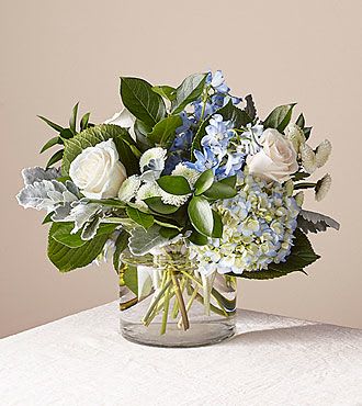 Clear Skies Bouquet - Let this uplifting arrangement be reminders of the clear skies ahead. Capturing the feeling of hope that a new day brings, this bouquet is composed of voluminous hydrangea blooms and vibrant belladonna delphinium to refresh their mood.  Vase will be a different shape