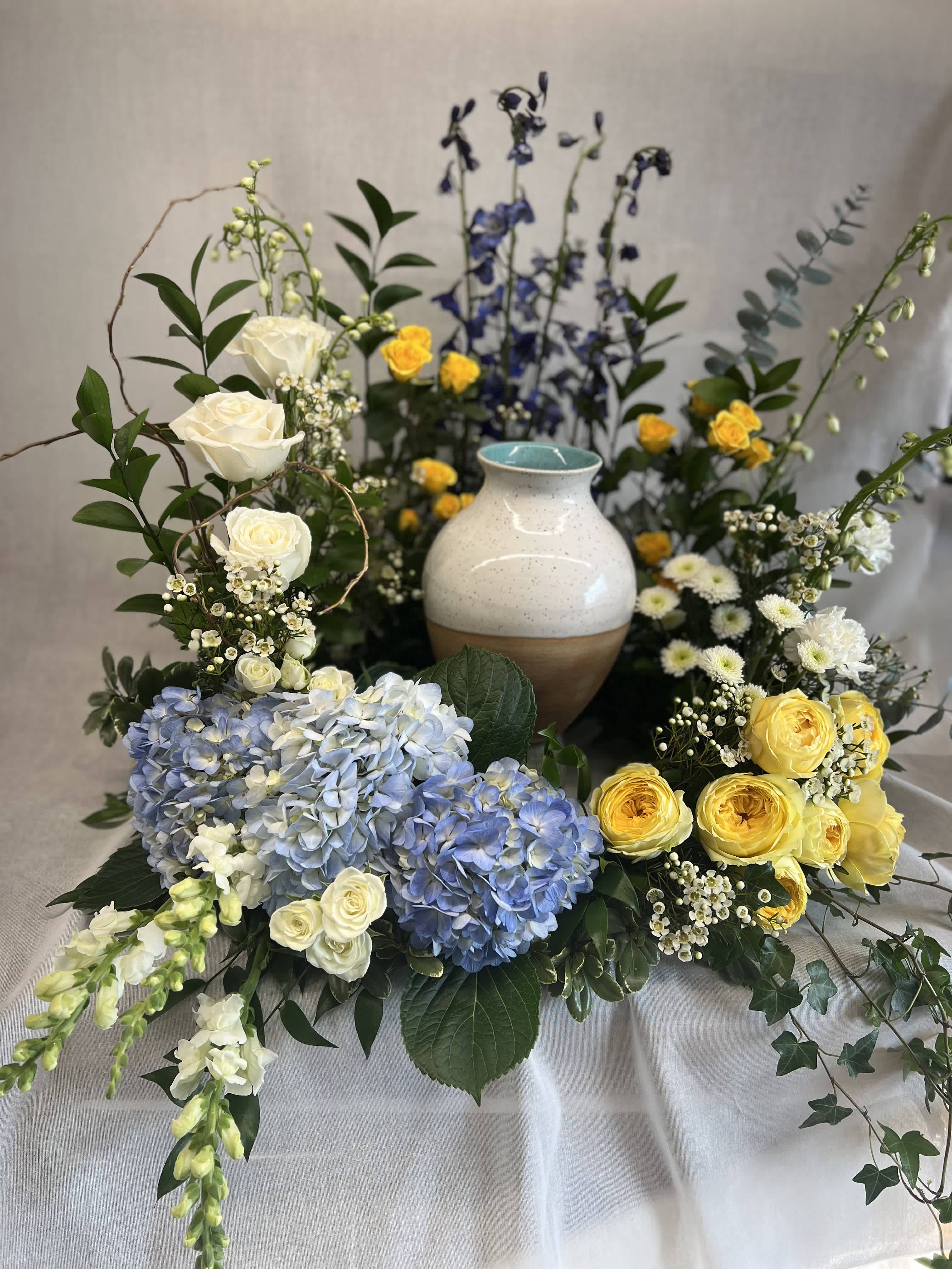 Sympathy - Urn Wreath - A beautiful way to display a funeral urn. Please call 613-687-2136 if you have special instructions for the colours or would like to add a customized ribbon. Deluxe shown