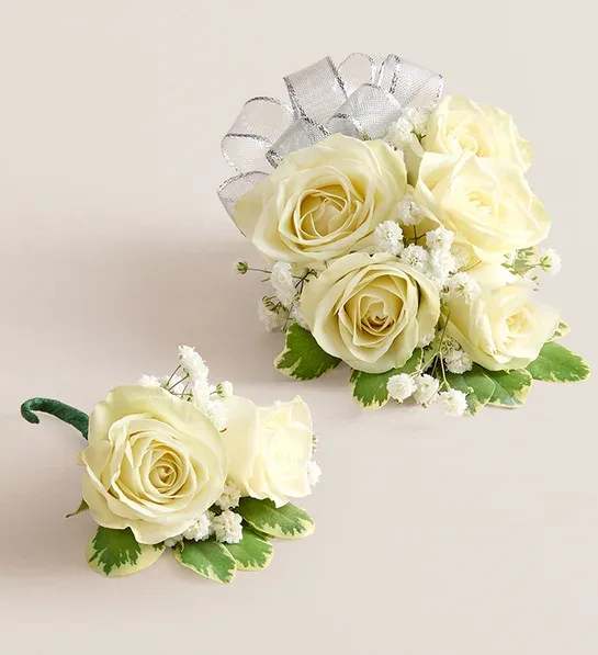 White Spray Rose Corsage & Boutonniere COMBO White Spray Rose Corsage & Boutonniere COMBO - Make a special occasion even more memorable with our hand-designed corsage and boutonniere pairing. Each is made with carefully chosen white spray roses complemented with baby’s-breath and greenery. Corsage features 5-6 white spray roses, baby’s-breath (gypsophila),greenery, and wristlet attached and measures 4”L; boutonniere features two white spray roses (or 1 regular size white rose to match, depending on availability!!), baby’s-breath (gypsophila), and greenery, and pin attached and measures 2”L.