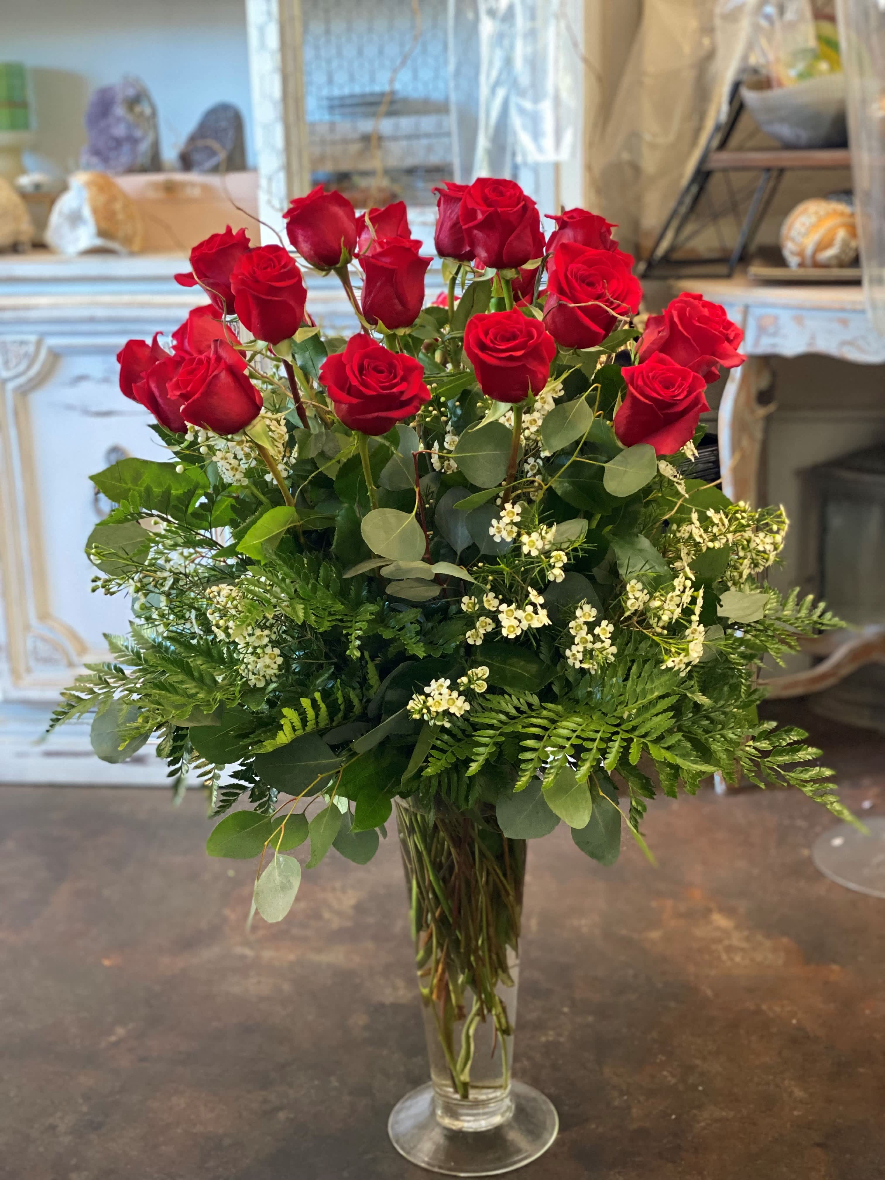 Be Mine Be Mine - Two dozen red long stem roses, mixed greens, filled with white wax flowers, designed in a tall glass vase with traditional look.