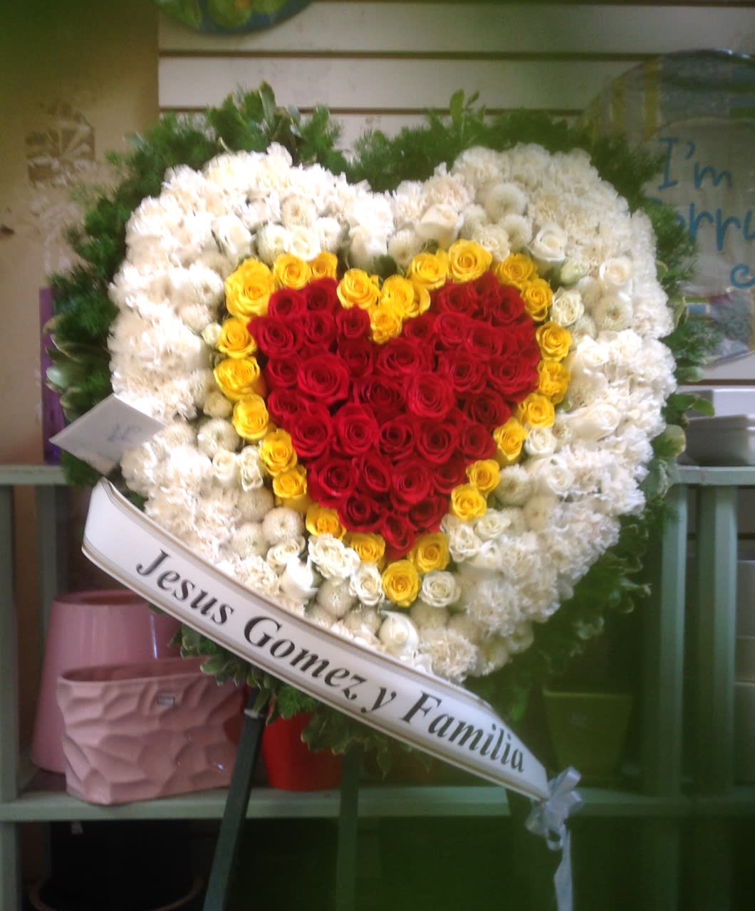 FROM YOUR HEART - SYM-231 FROM YOUR HEART - SYM-231 - A beautiful solid heart made with white carnations, yellow and red roses. **Price does not include a printed banner. Picture is Premium size.