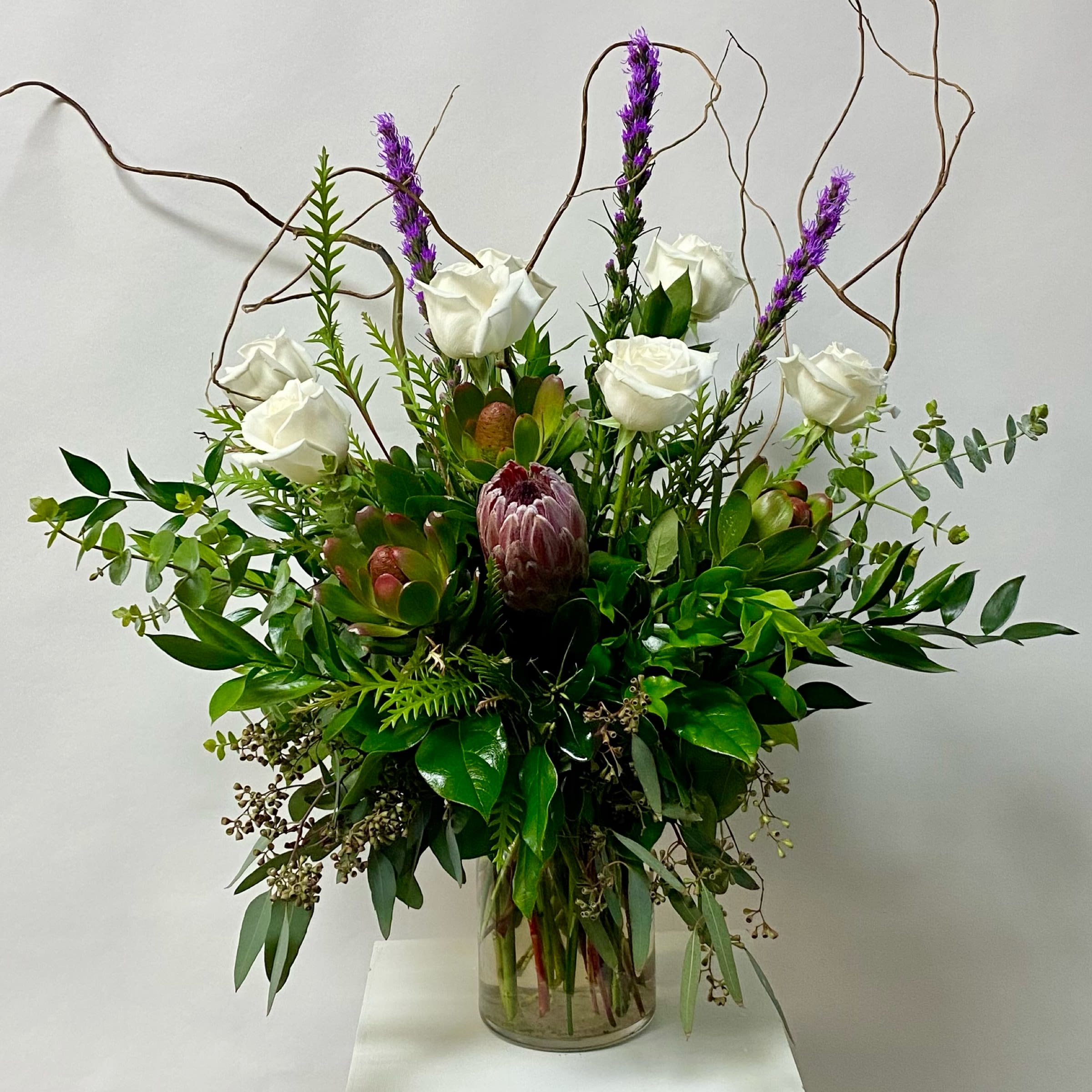 Meadow's Crossing Arrangement - Picture shown is the Premium Size. Feathers not included. Designers Choice Item. Made slightly different every time with freshest selection. 