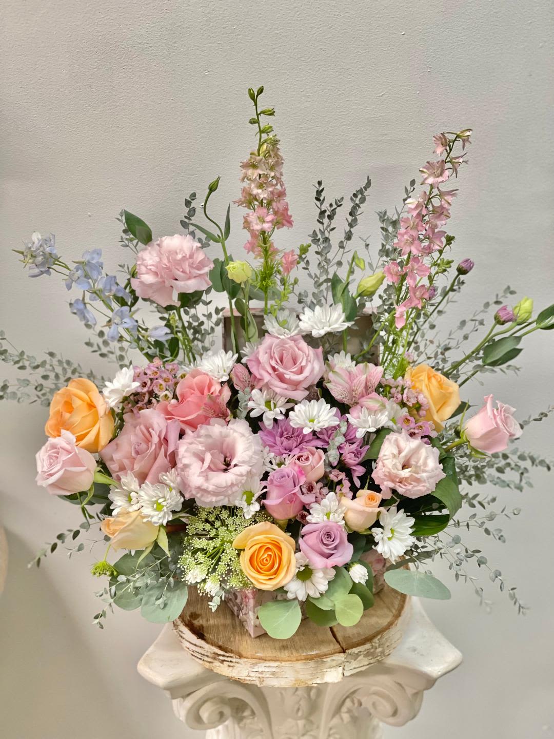 Be happy -  Product Information Theme Colors: Shades of light pinks, purples and peachy.  Featured Blooms: Roses, Spray Roses, Chrysanthemums, Lisia thus, Delphinium, wild greenery, Seasonal Blooms in the pink box  HK Flowers have a uniqueness of florals and seasonal blooms, certain flowers or colors may not be available as each season affects the availability, color, size, and shape of each floral bloom. Some flowers may be substituted accordingly.  Photos are used as a reference for the color palette and is NOT indicated of the final product. We ask for your trust in us that we will pick out the best seasonal available blooms, while still capturing the arrangements' theme and colors mentioned above.