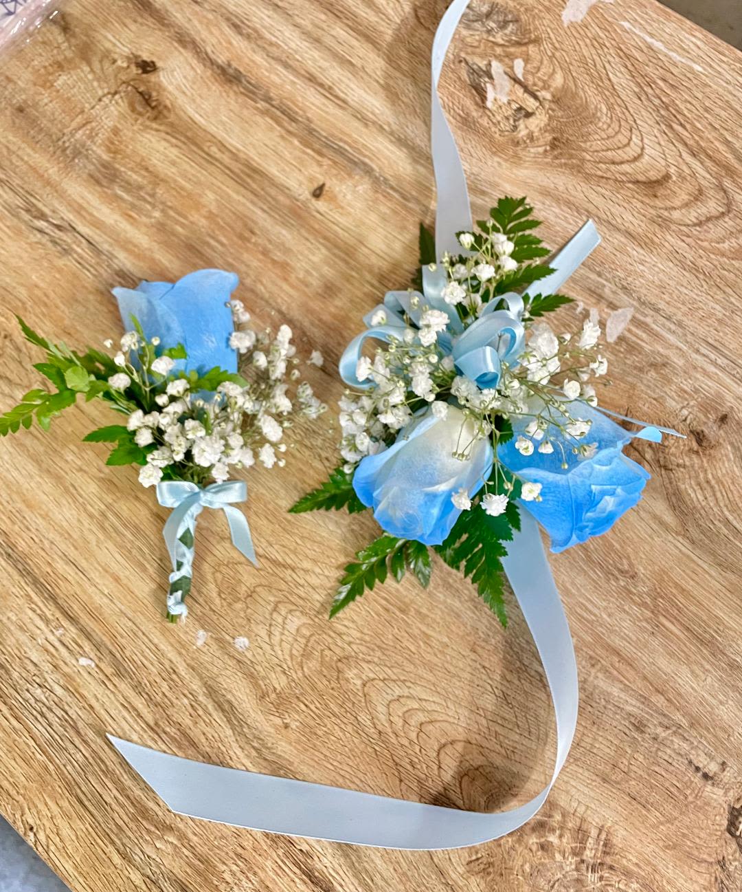 Secret Gardenia Corsage and Boutonniere Set  - Made from fresh flowers, a corsage looks like a petite flower arrangement (typically consisting of just one or several smaller blooms) and usually sits on the wrist like a bracelet, though it can also be pinned on a lapel. Corsages serve as a way to honor people who are very important to the couple getting married. Please contact our shop at (747) 249-4678 for any customization. 