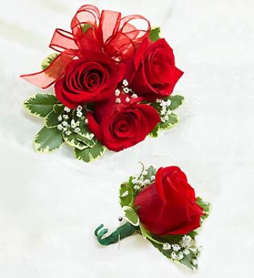 Red Rose Corsage &amp; Boutonniere - Make them stand out in a crowd with this classic corsage arrangement and boutonniere. For proms, weddings, or any celebration, our expert florists have hand-designed a stunning red rose wrist corsage that will make her the hit of the party. Pair it with the matching red rose boutonniere for an added touch of elegance.  Beautiful hand-designed corsage arrangement of red roses, accented with fresh greenery 