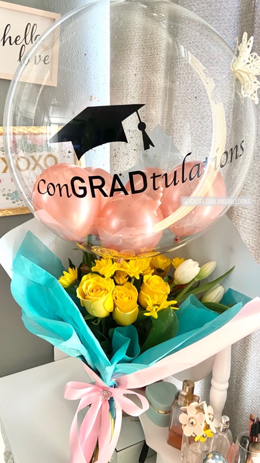 ConGRADtulation bouquet - Send this unique floral bouquet with a customized balloon to your loved ONE to honor their success. We can use different color of flowers or paper...  Please let us know your request on Special instructions. Balloon: Color of flowers &amp; Paper: 
