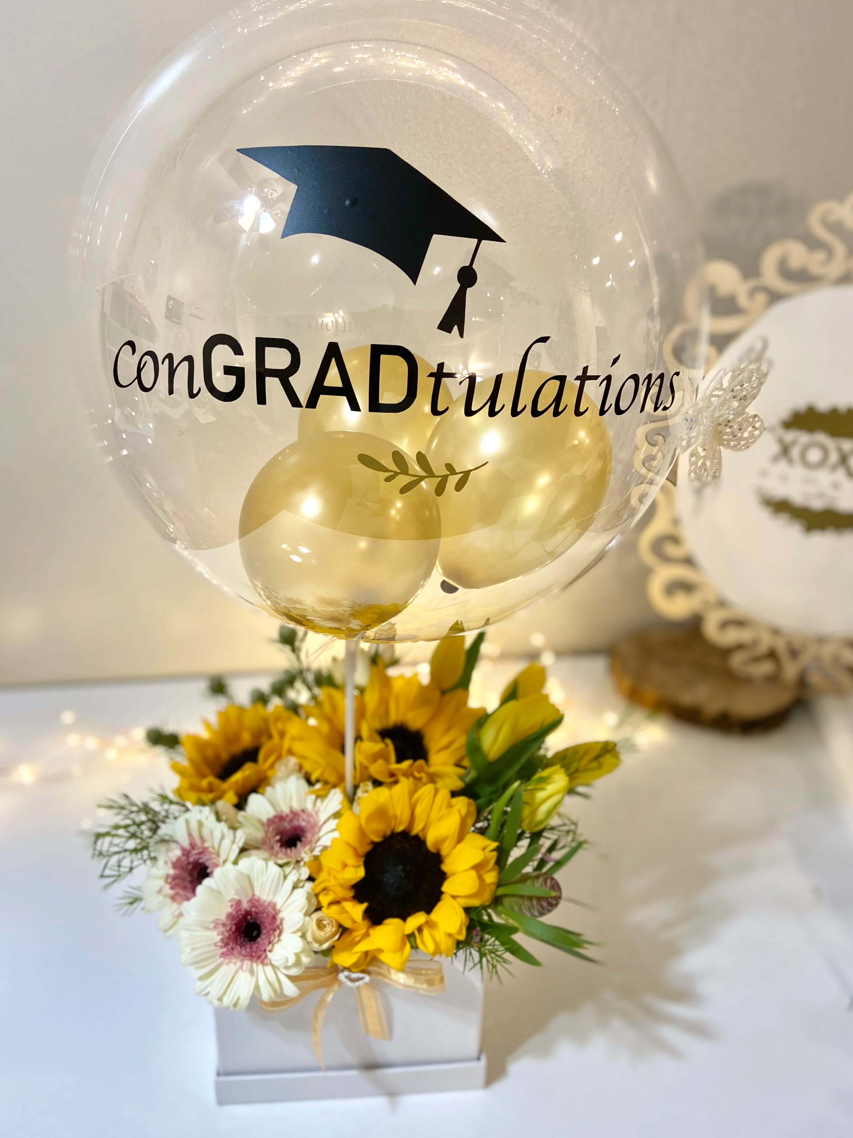 conGRADtulations floral - WE ALWAYS HAVE SPECIALS!! Send this beautiful customized bubble balloon with a fresh mix boxed floral arrangement to your favorite GRADUATE   ^^CUSTOMIZE YOUR ORDER^^ Once you click on &quot;ORDER NOW'  your next step is to tell us what you will like to say on the BALLOON and CARD MESSAGE on &quot;Special Instructions&quot;  Example:  BALLOON: I LOVE YOU Card Message: Happy Birthday to the greatest person in the whole world!!  Love, Your Husband.   