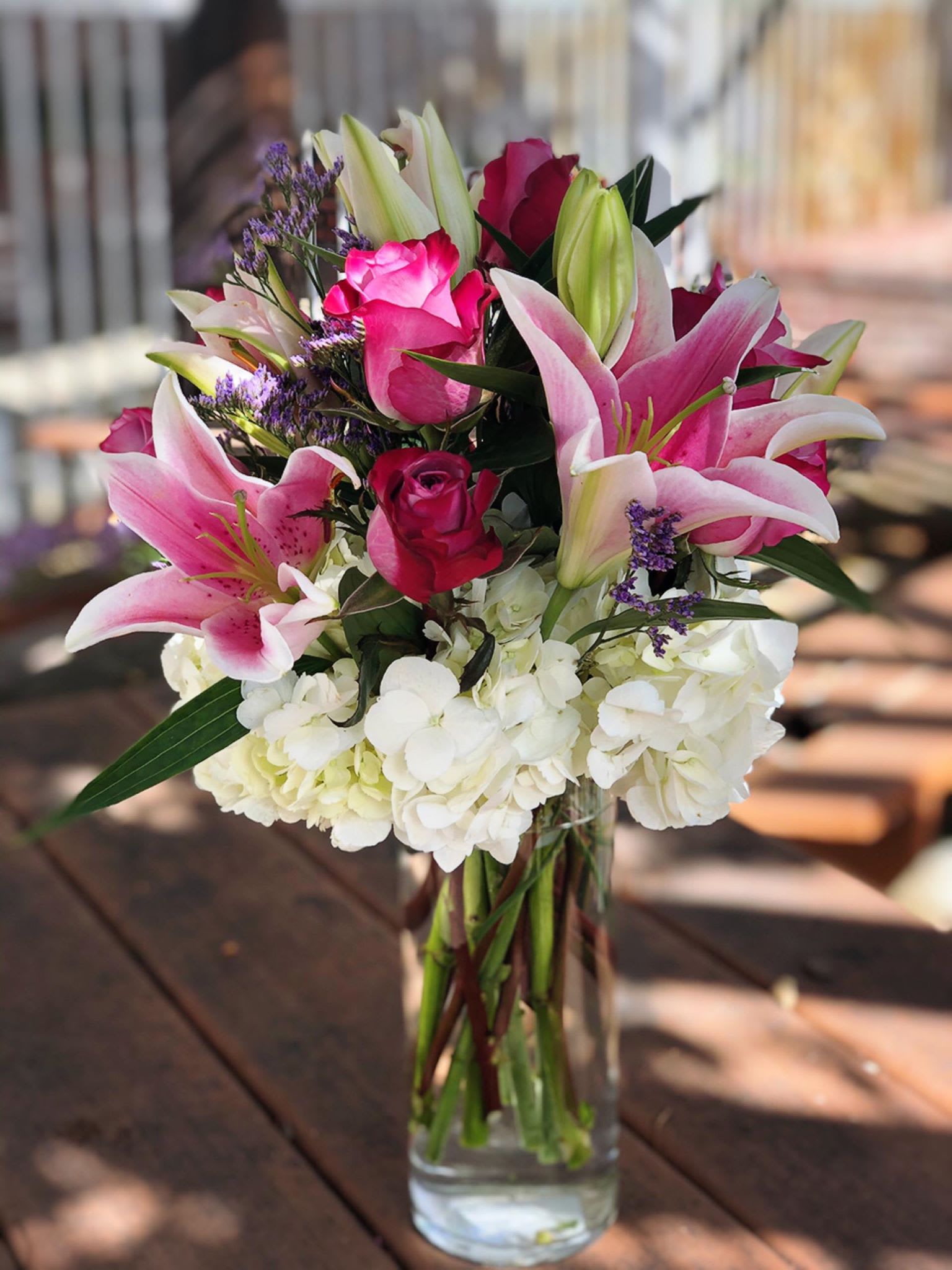 Impression Impression - -6 purple roses -3 Pink Lillies - White Limoniums -3 White Hydrangeas - 8 inches Vase