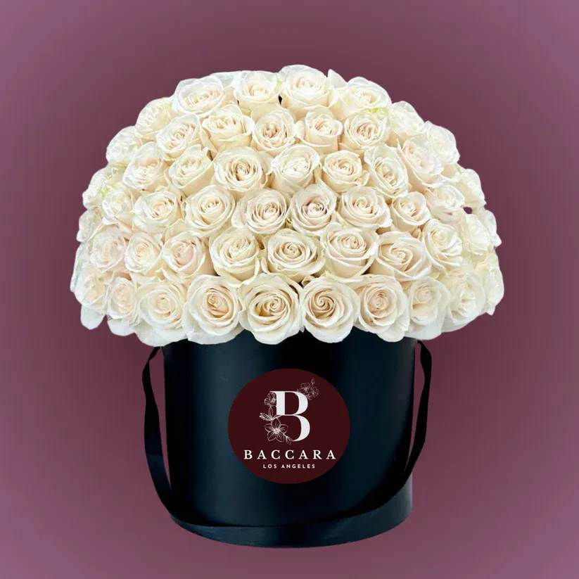 Pure Grace: White Rose Box Pure Grace: White Rose Box - Elegant, serene, and timeless — our Pure Grace Rose Box features handpicked white roses, beautifully arranged to capture the essence of purity and classic charm. Ideal for weddings, anniversaries, sympathy gestures, or simply to express heartfelt sentiments, this sophisticated arrangement is both meaningful and memorable. Choose your desired size — from a simple, delicate collection to a grand, luxurious display. Each rose is carefully selected for its pristine white petals and fresh, velvety texture, elegantly presented in a chic, modern box. Highlights: Premium, hand-selected white roses arranged in a stylish box Multiple sizes available — select the perfect one for your occasion Ideal for weddings, sympathy, anniversaries, or special surprises Optional personalized message card and elegant wrapping Let the timeless beauty of white roses deliver your message with quiet elegance and grace. Disclaimer: Product images are for reference only. Actual flower shades, box colors, and arrangement styles may vary slightly based on seasonal availability and stock. We always strive to match the overall style, color palette, and quality shown in the photos, ensuring every arrangement is fresh, beautiful, and thoughtfully curated.