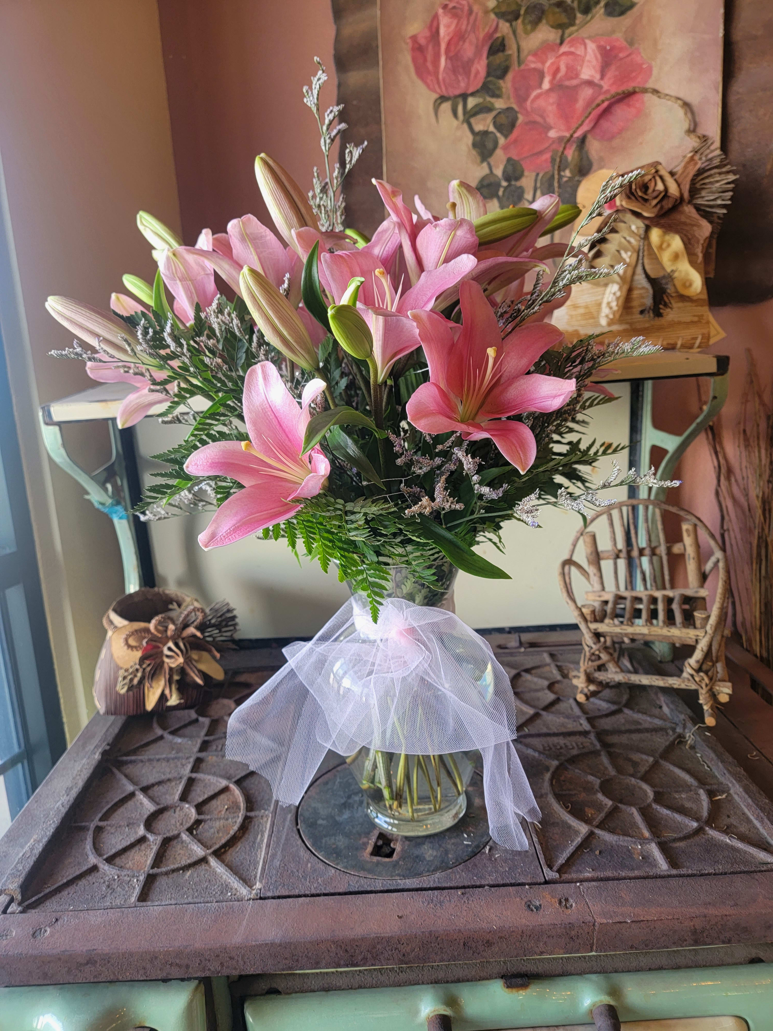 To the Moon and Back To the Moon and Back - She will love you to the moon and back. This stunning arrangement is sure to brighten anyone’s day. Packed full of fragrant lilies, Limonium Lacy and Leather greens in a clear glass vase. Color Choice of pink, white, red or mix it up. Just add color choice in notes during checkout.