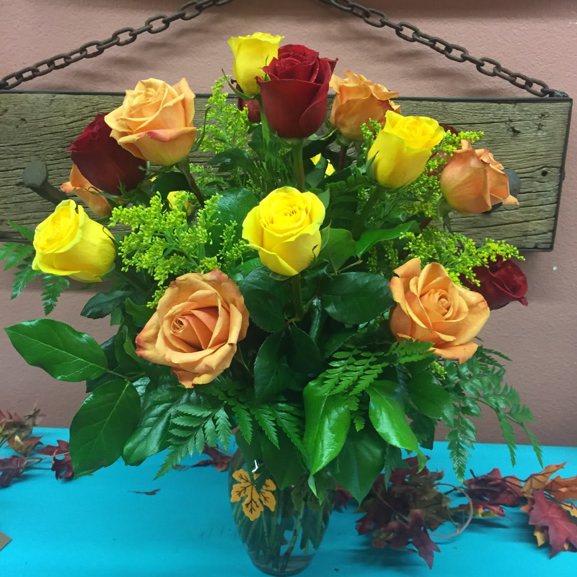 Autumn Roses (pictured in standard) Autumn Roses (pictured in standard) - A beautiful Mix of Orange, Red and Yellow Roses Arranged in a clear glass vase. Regular comes with One Dozen Roses, Deluxe includes Eighteen and Premium will be the fullest bouquet with Two Dozen Roses.