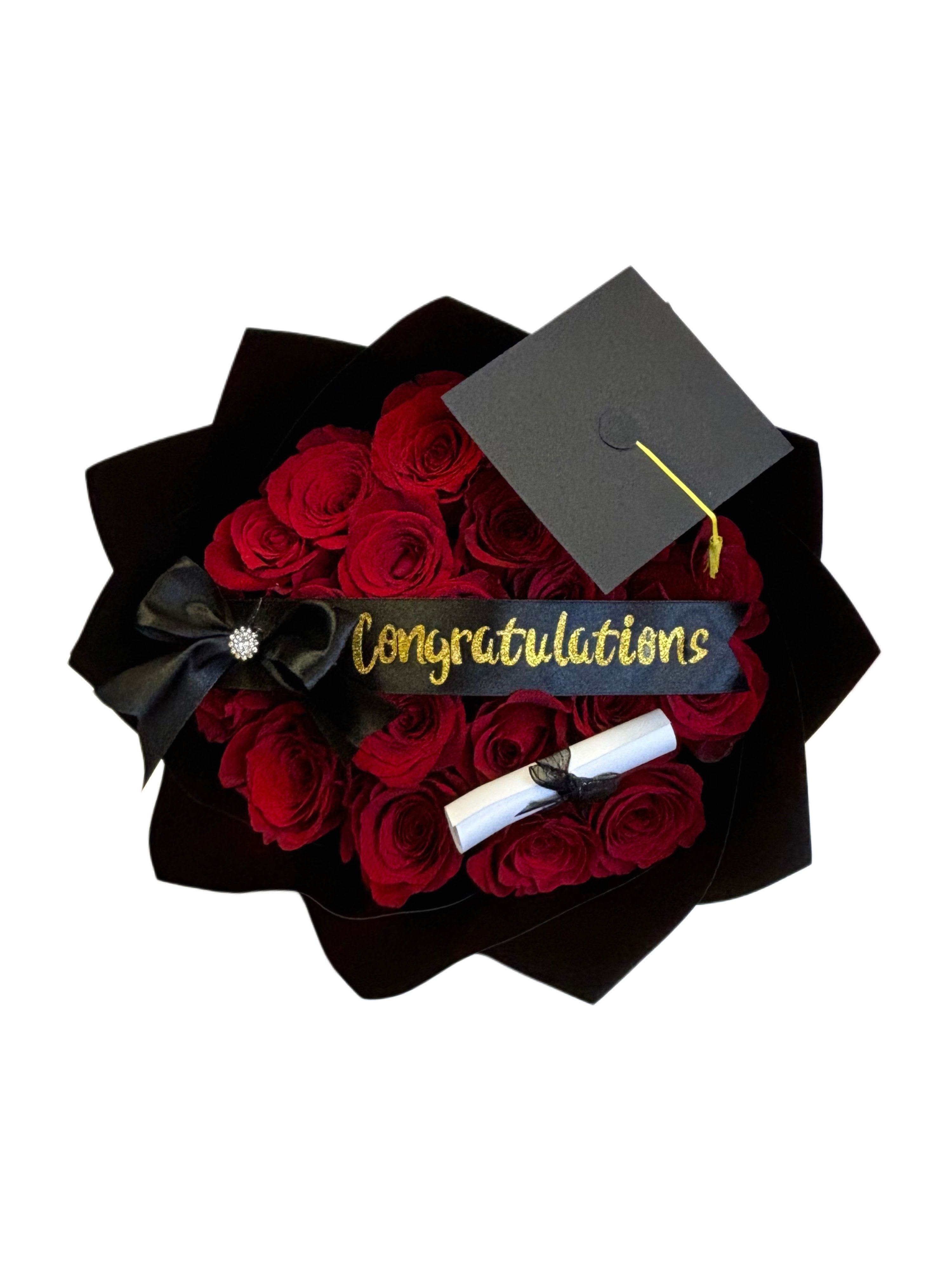 Graduation Bouquet  - Graduation Bouquet A stunning bouquet wrapped in elegant black paper, featuring soft pink roses that transmit admiration and joy. Accented with delicate white baby’s breath and a bold ribbon that reads “CONGRATULATIONS ,” this bouquet is the perfect way to honor a graduate’s big moment. Its sophisticated design includes symbolic touches of celebration, making it ideal for gifting with pride and elegance