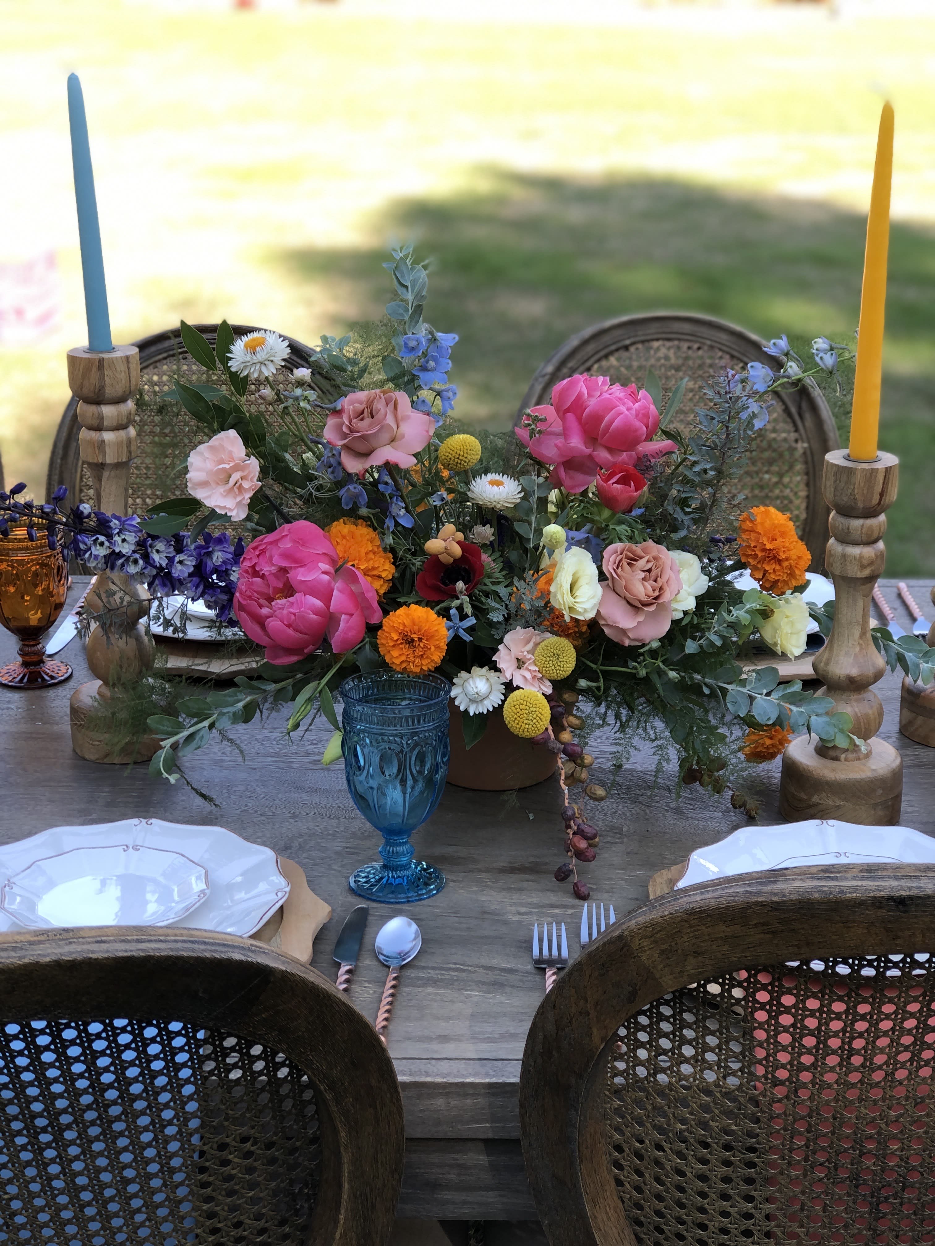 Gather Centerpiece  - Bring the tranquility of nature inside with a little help from some fresh floral art.  Light the candles and pop the cork, the good vibes and conversations are flowing all night. Each centerpiece is designed with a variety of fresh foliages and floral to fit the season.   Measuring approx. 8in tall, 9in wide 