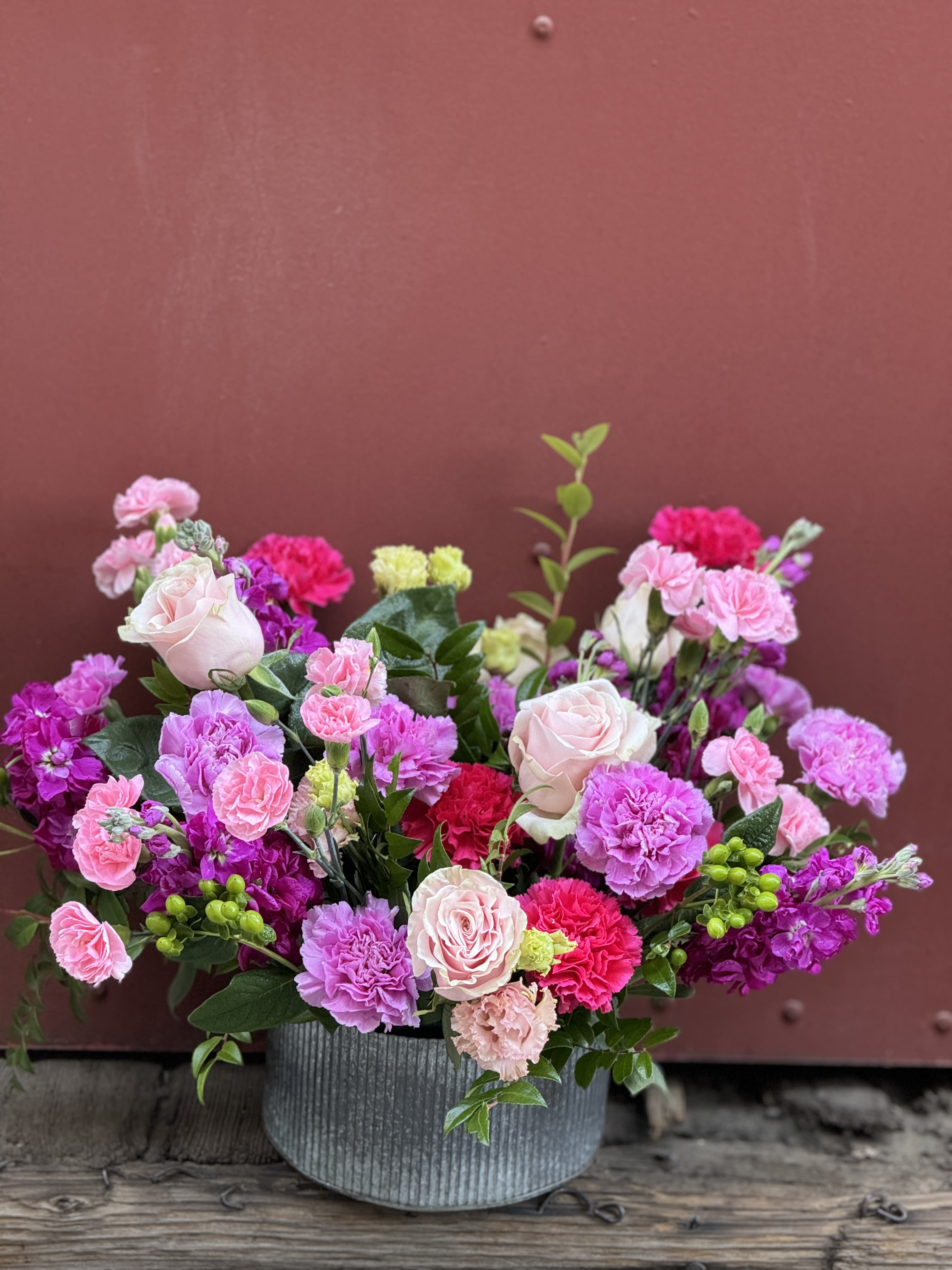 Tickled Pink Tickled Pink - The color pink represents Love, Femininity, Health, Happiness & Friendship. This arrangement carries a lovely array of long lasting flowers in the pink spectrum, crafted by our talented designers in a galvanized tin vessel. Tickle them PINK!