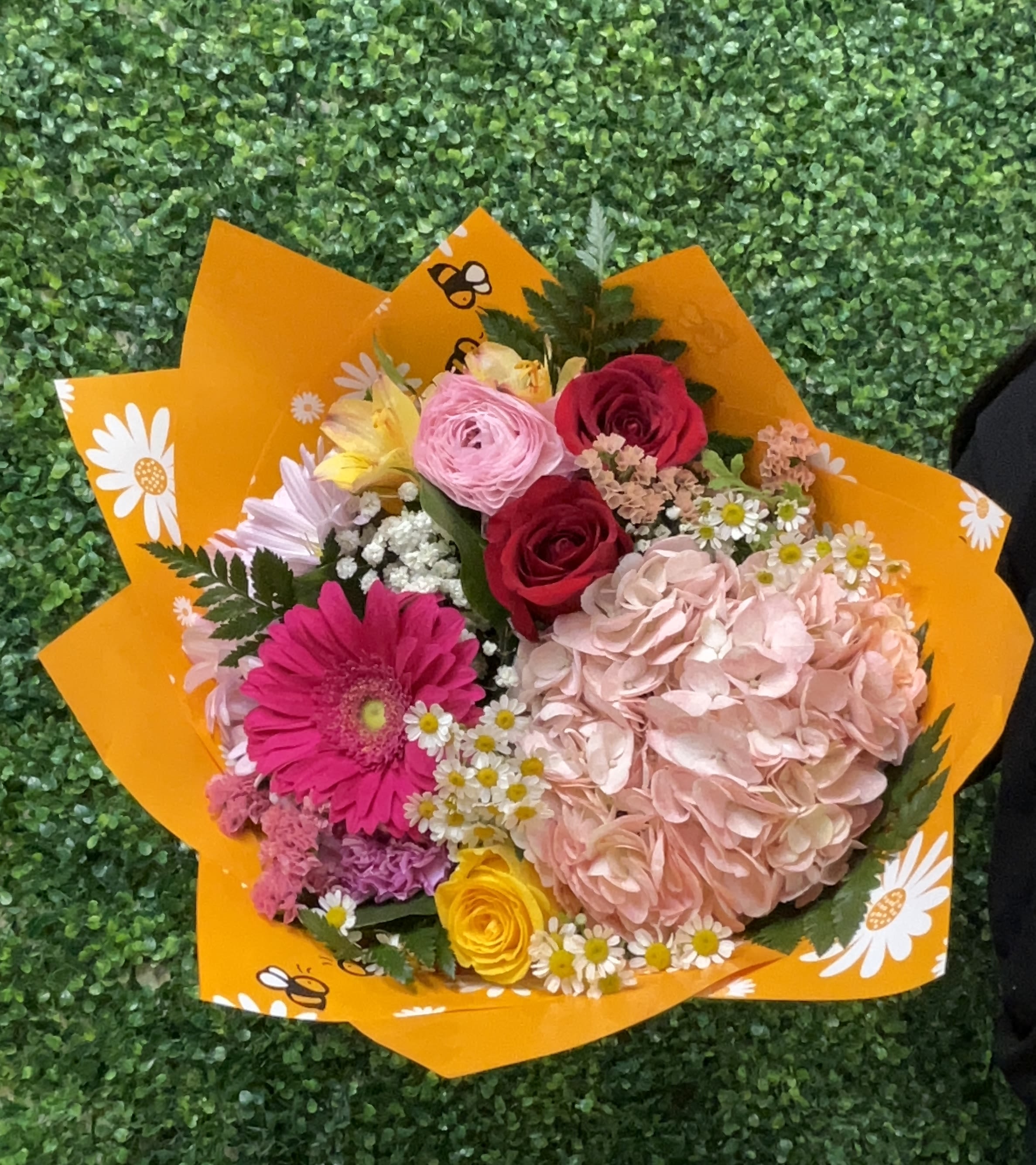 Designers Choice Mix Bouquet - Our designers picks out a fresh selection of mixtures in florals and wrap. This design is without a vase in a hand held bouquet. There are no specifications in florals due to designers choice and our designer will choose a nice wrap to go with the florals. The photos represent an overall design of the possible outcome, not an exact look. 