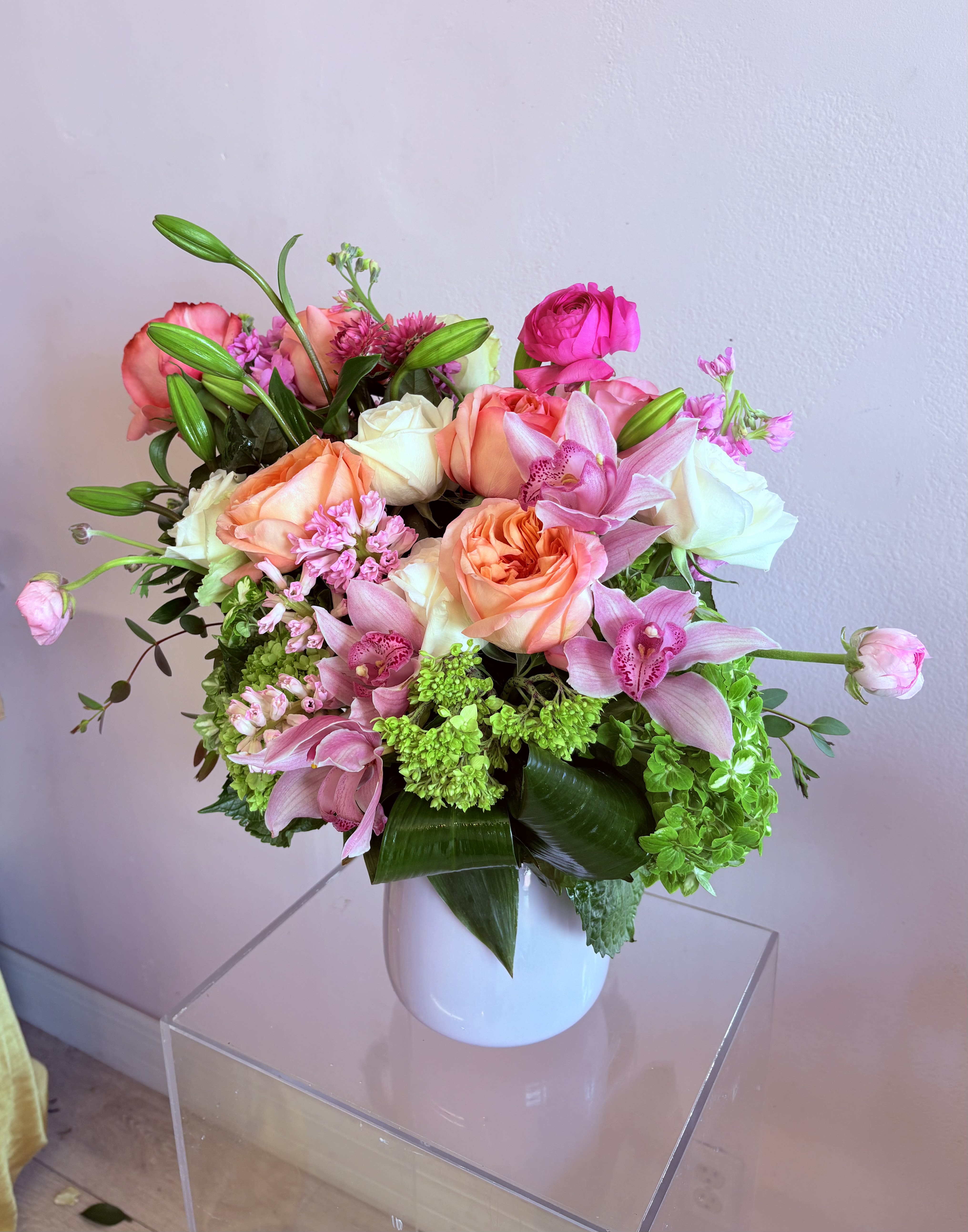 Pink Garden with orchids Pink Garden with orchids - Varying shades of pink garden roses accent with ranunculus, green hydrangeas and pink cymbidium orchids