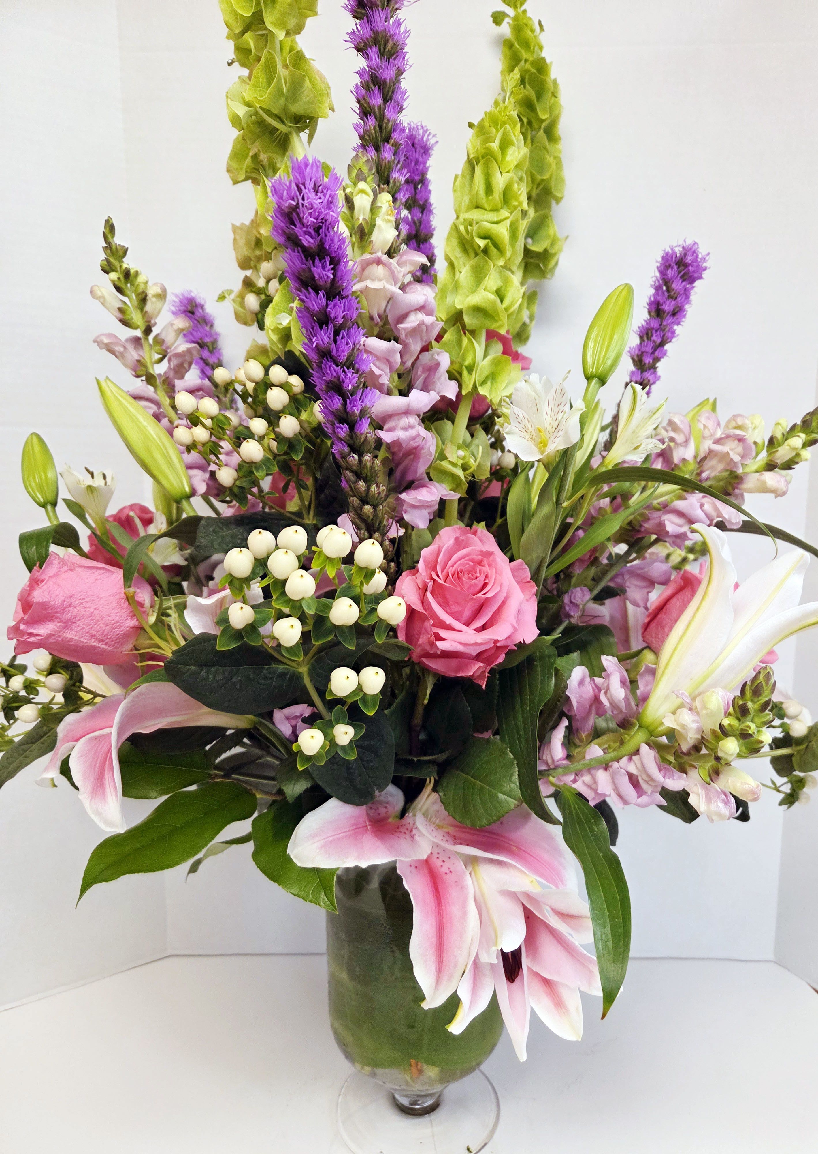 PRESIDENTIAL - PINKS &amp; PURPLES IN LILIES, ROSES, ALSTROMERIA, SNAP DRAGONS AND LIATRIS ALONG WITH BELLS OF IRELAND, ON A GRAND SCALE.