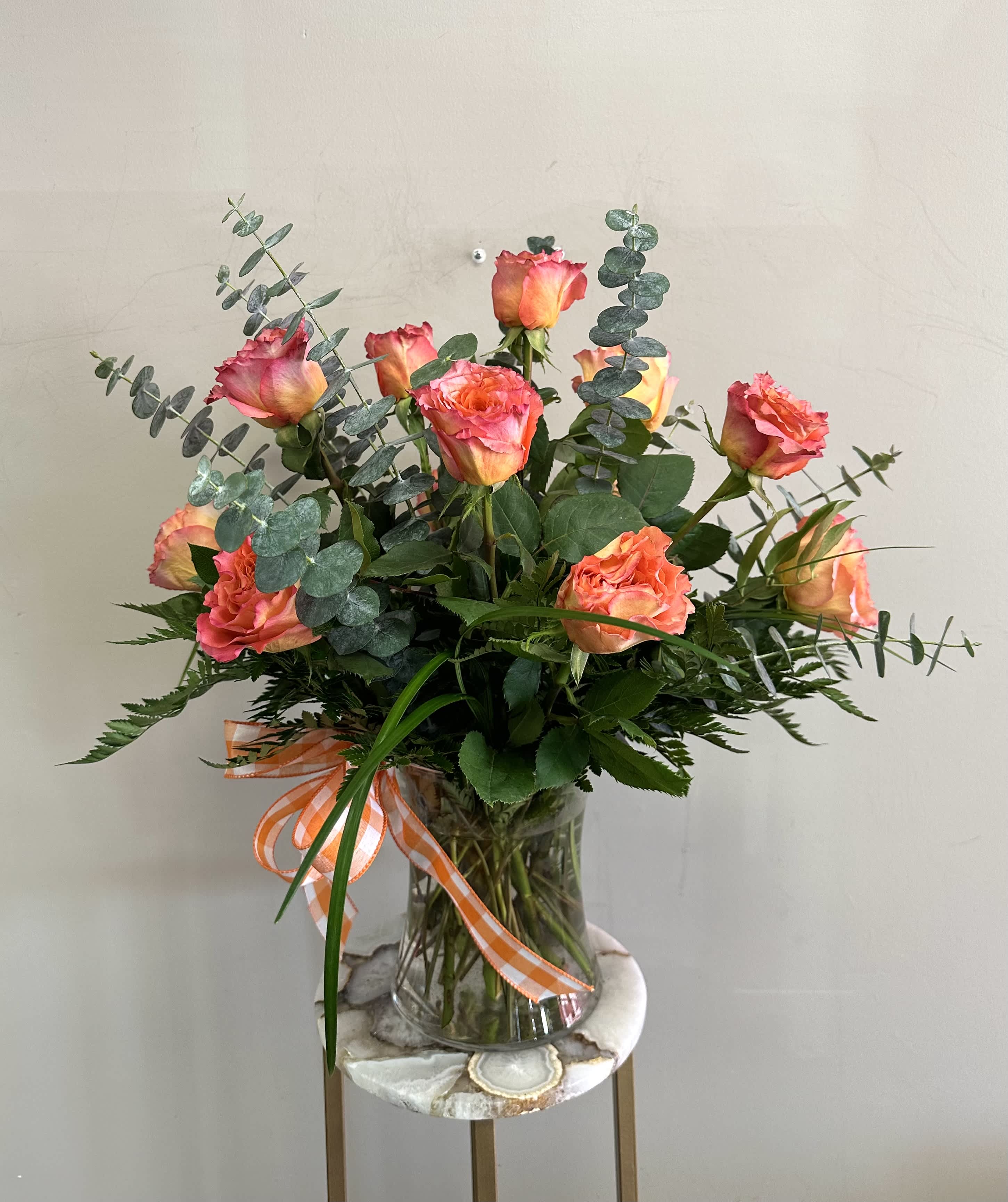 Free Spirit Dozen Roses - A dozen free spirit roses with spiral eucalyptus in a clear glass vase. These roses are the perfect gift for anniversaries, birthdays, retirement, or even just because! Order for a same day or next day delivery and give us a call if you want custom flowers. 