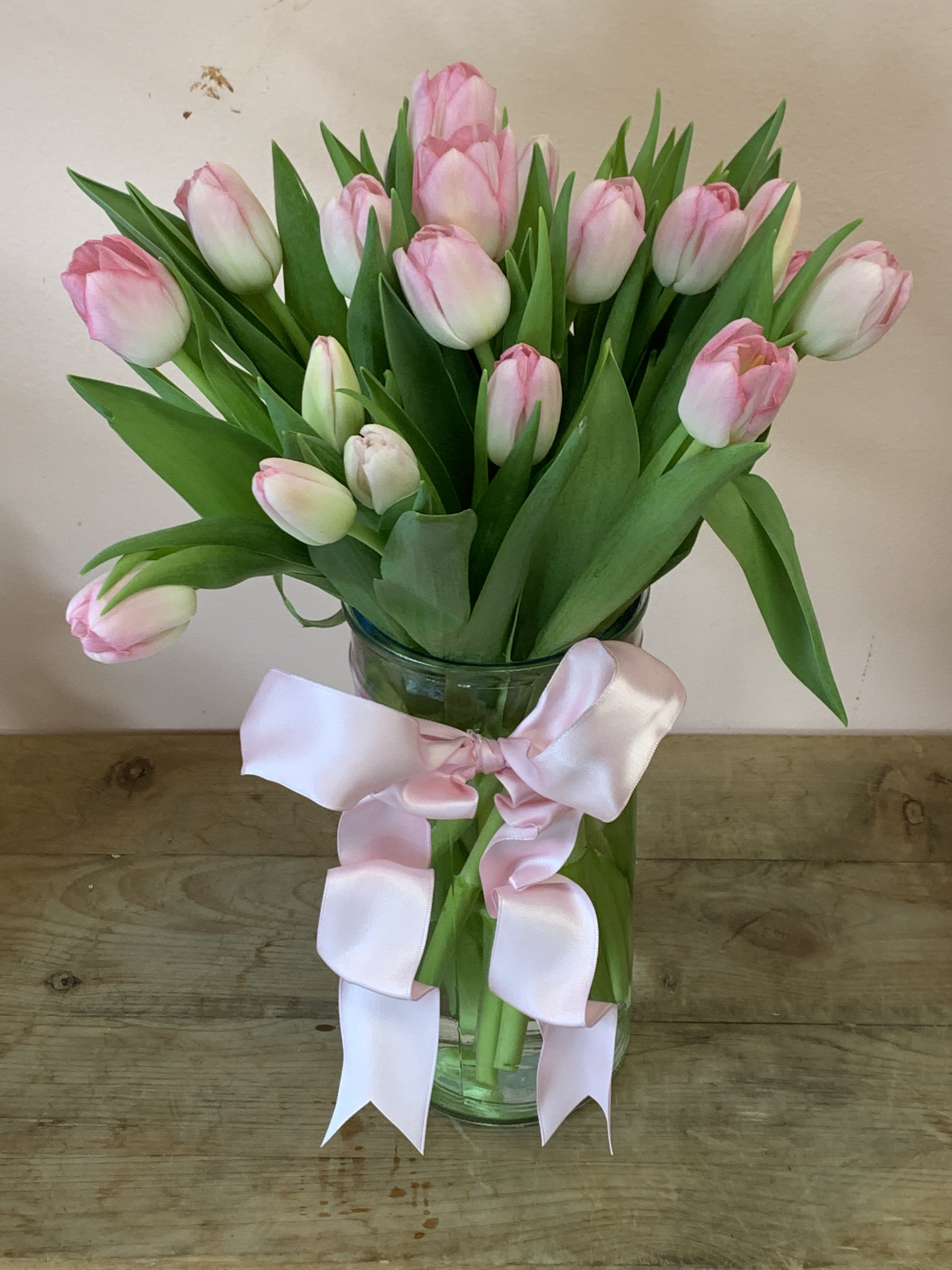 20 Pink Tulips in clear glass vase - W815 - Beautiful and 'simply said' light pink tulips are a hip way to show you care. Twenty delicate light pink Tulips arranged in a clear glass vase. As Shown : W815