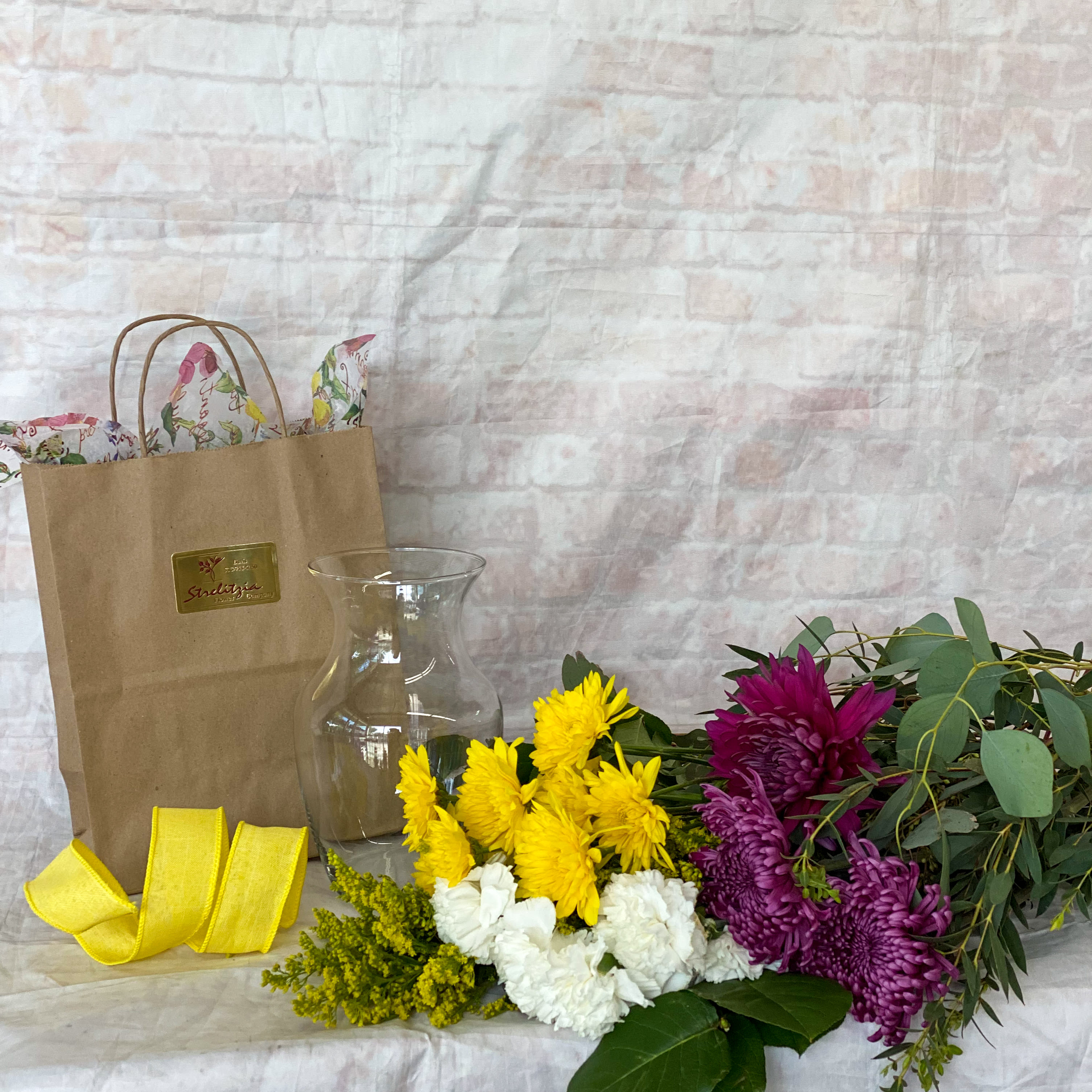 DIY Kit - Get creative at home with this vase arrangement DIY kit. Includes clear vase, ribbon, assorted focal flower, filler flower and mixed greenery.  Colors and flowers may vary.  Can request specific color palette in special instructions. 