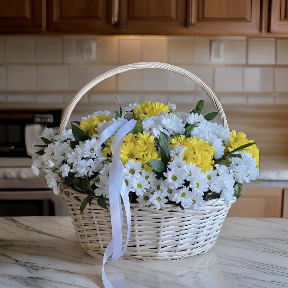 Chrysanthemum Bliss Basket - The &quot;Chrysanthemum Bliss Basket&quot; is a delightful arrangement of vibrant chrysanthemums beautifully displayed in a rustic wicker basket. This bouquet captures the essence of cheerfulness and warmth with its lush, full blooms. Perfect for any occasion, this charming basket adds a touch of natural beauty and elegance to any setting, making it a wonderful gift to brighten someone's day.