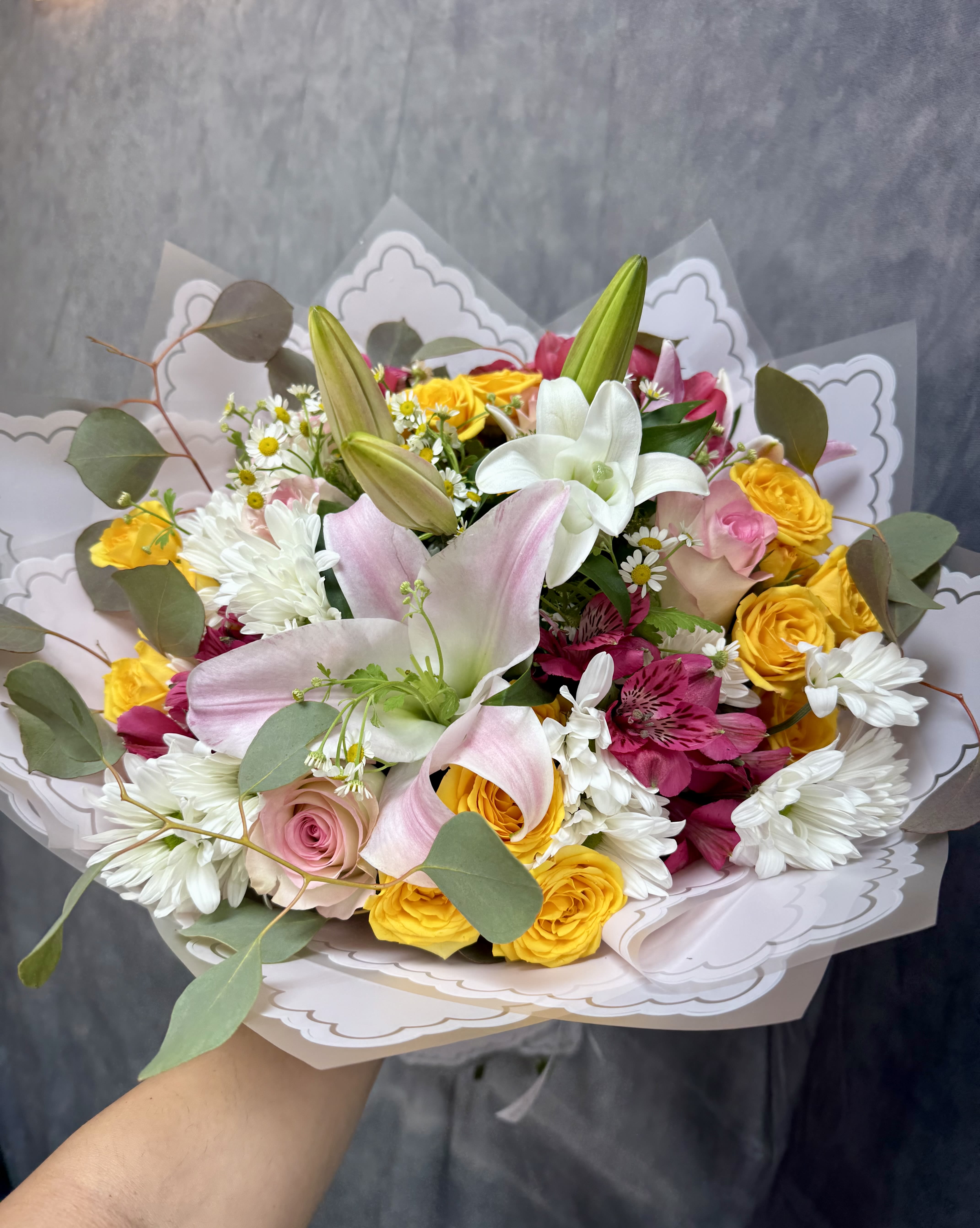Beauty Mist Bouquet  - Beauty Mist Bouquet is a dreamy and elegant arrangement that exudes softness and sophistication. Featuring graceful lilies, delicate spray roses, and romantic roses, this bouquet captures the essence of tranquility and beauty. Perfect for celebrating love, expressing sympathy, or simply bringing a touch of elegance to any space.