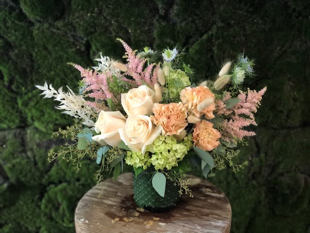 Vintage Whimsy - A whimsical selection of soft blush blossoms accented with seasonal woodland textures and foliage.  This arrangement is the perfect size for a desk, hospital room or coffee table.   Approx. 9x9