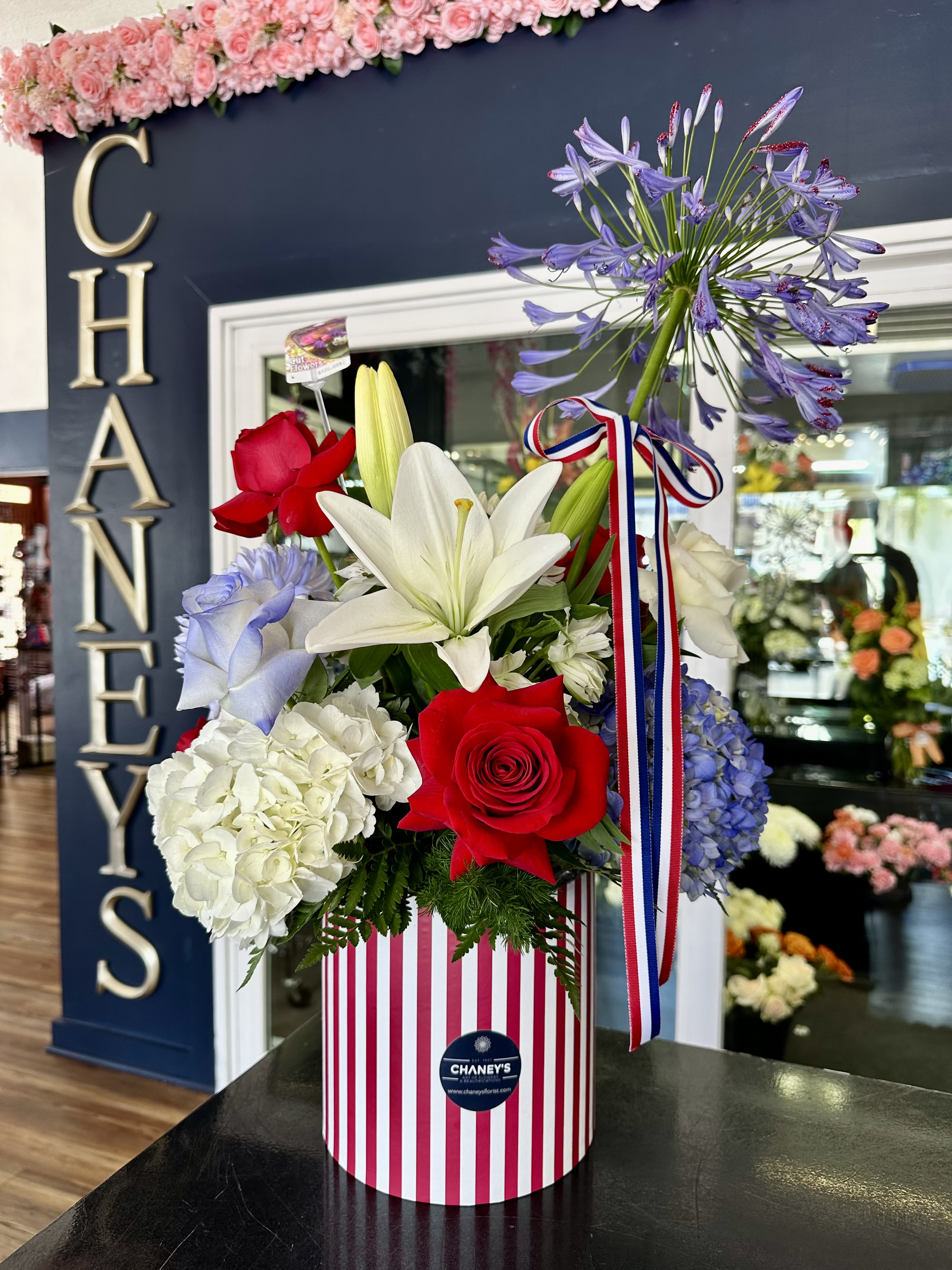 Chaney‘s God bless America! 1001 - Chaney‘s floral interpretation of celebrating and honoring the United States of America. A firework of unique floral design in Blue, Red and White!