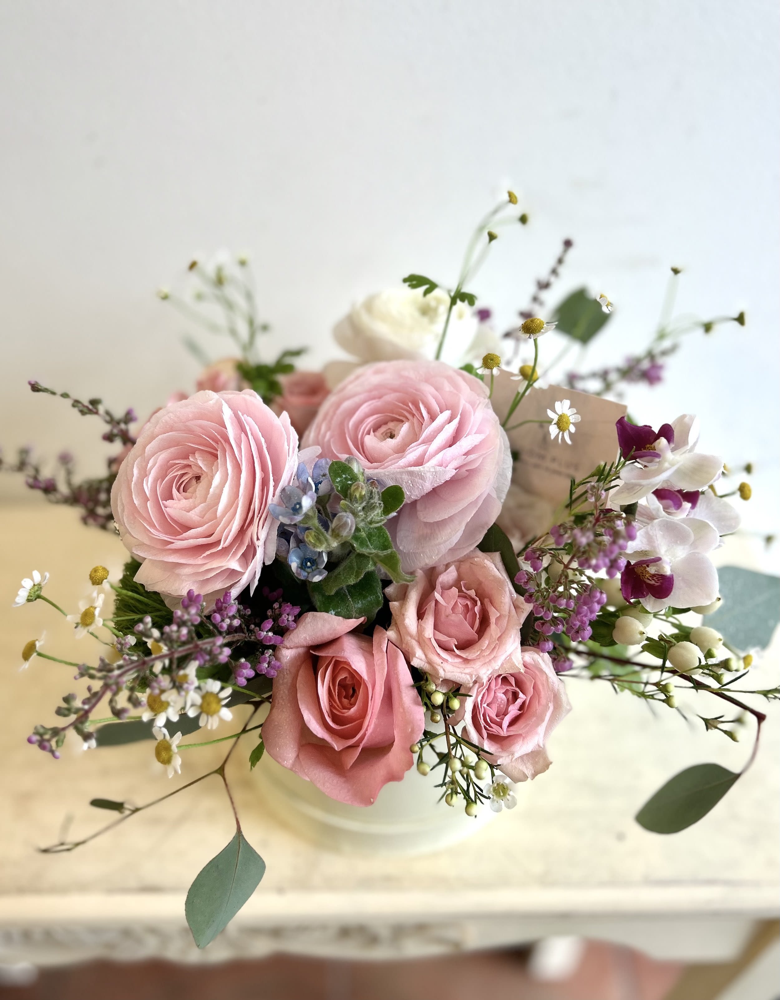 Ranunculus Blossom Ranunculus Blossom - A beautiful mix of delicate ranunculus and classic roses in stylish box.