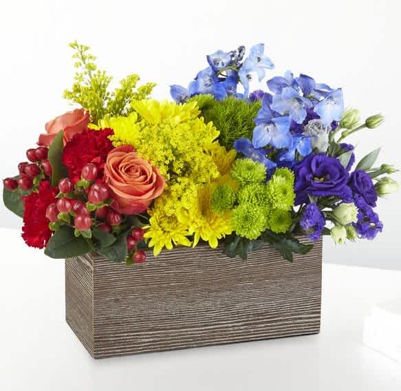 Color Of Love - This bouquet is all about capturing the color of your unique love. With a rainbow color pallete, this arrangement has everything from bold reds to vibrant violets, and the all gorgeous hues in between! Our Color of Love Bouquet is made up of a wide array of blooming beauties like carnations, roses, button pompons and more.
