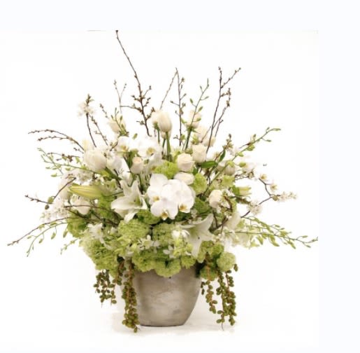 White Mist - White Mist is an elegant floral arrangement featuring a harmonious blend of white blooms and some touch of greens. This sophisticated bouquet captures the essence of tranquility and purity, offering a timeless and serene display. Perfect for any occasion, &quot;White Mist&quot; brings a touch of grace and refinement to any setting.