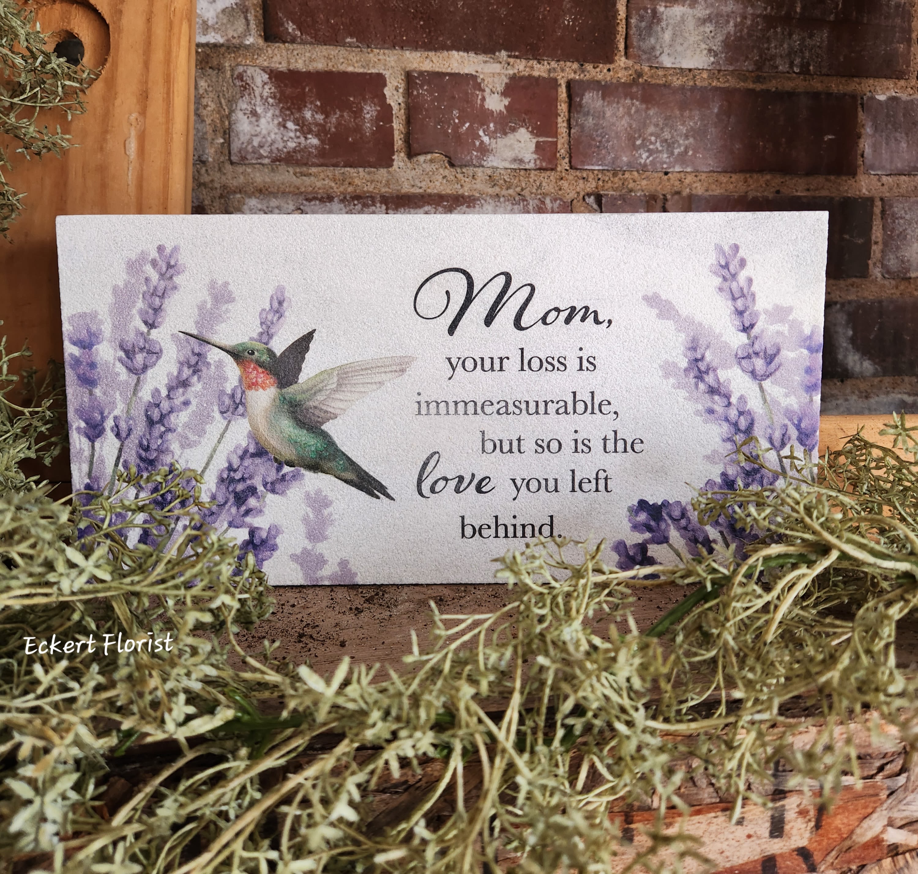 Eckert Florist's "Mom, your loss..." Marble Paver Memorial Stone *Our Local Delivery Only Eckert Florist's "Mom, your loss..." Marble Paver Memorial Stone *Our Local Delivery Only - This fine Turkish Marble weather friendly stone will make a perfect memorial gift. Sentiment on stone: "Mom, your loss is immeasurable, but so is the Love you left behind." Designed and printed in the USA, this stone measures 6" H x 12" W x 1" *Our Local Delivery only