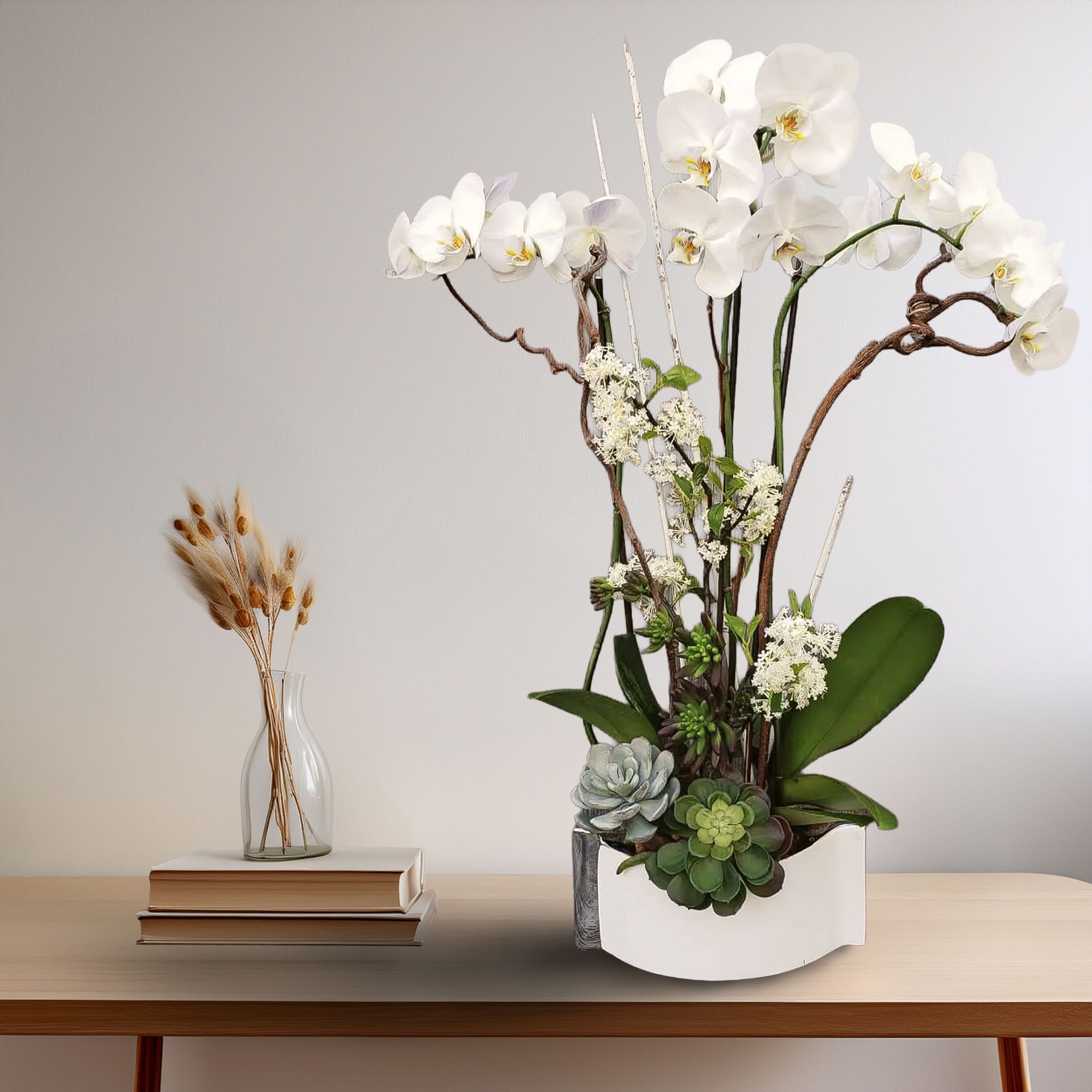 Orchid Balance Orchid Balance - This sculptural floral display features tall, graceful white Phalaenopsis orchids artfully arranged with green dianthus, white stock, and an assortment of premium succulents at the base. Set in a sleek, modern white ceramic crescent planter, this piece offers a refined and minimalist aesthetic with natural texture and movement. Ideal for luxury home décor, corporate gifting, sympathy tributes, or contemporary event styling, this arrangement brings long-lasting elegance and architectural beauty. Its clean lines and sculpted blooms make it a timeless centerpiece for any high-end interior. Available for same-day flower delivery in Los Angeles, including Beverly Hills, Bel Air, West Hollywood, and Marina del Rey.