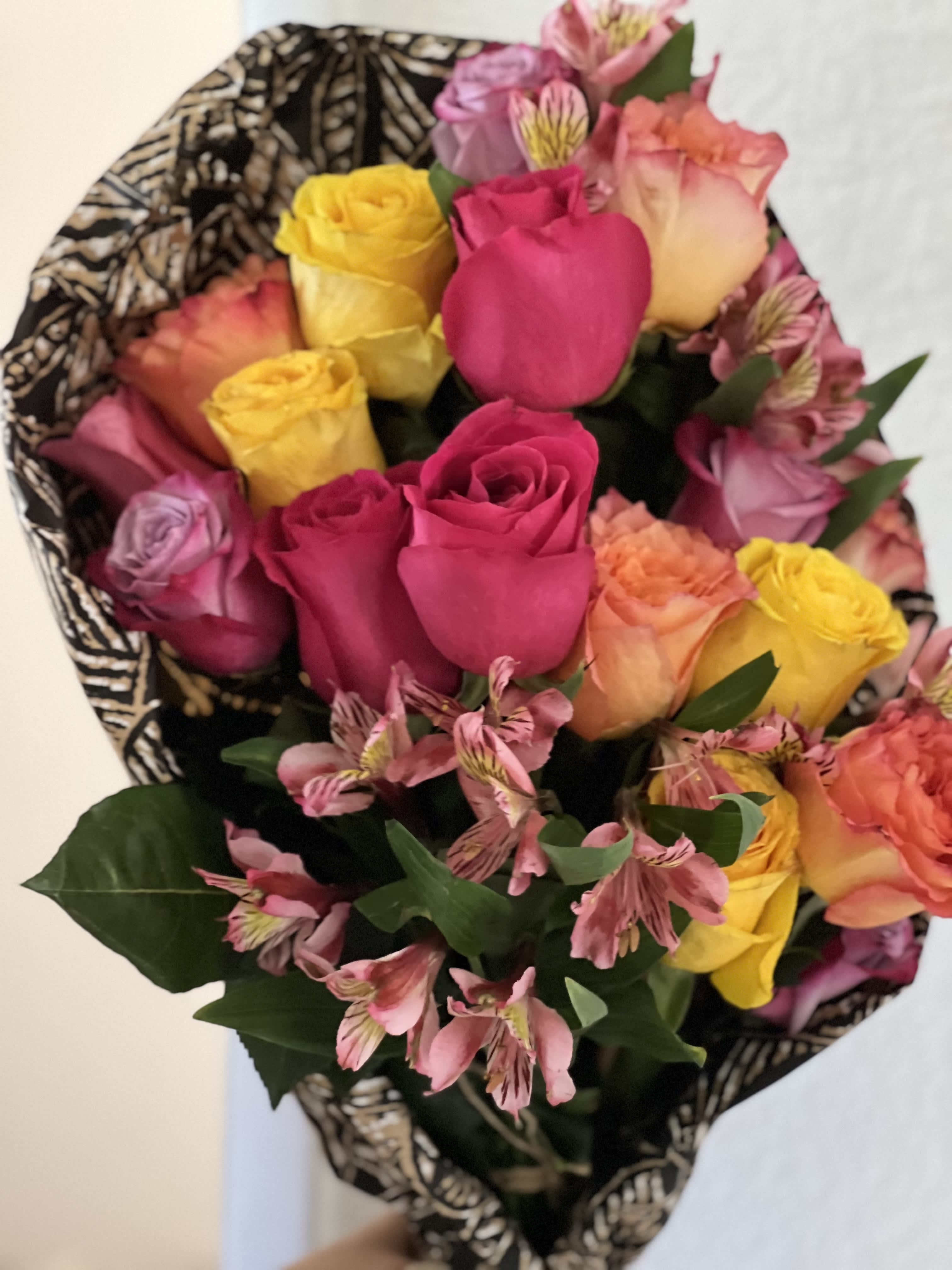 Kailua Smiles - A rich riot of colors, this mixed arrangement makes a big impression with all its different textures and premium flowers. Featuring red roses, peach snapdragons, bells of Ireland, purple hydrangea, and stock this arrangement makes a great anniversary or congrats gift.  Approximate Dimensions: 18&quot;D x 25&quot;H