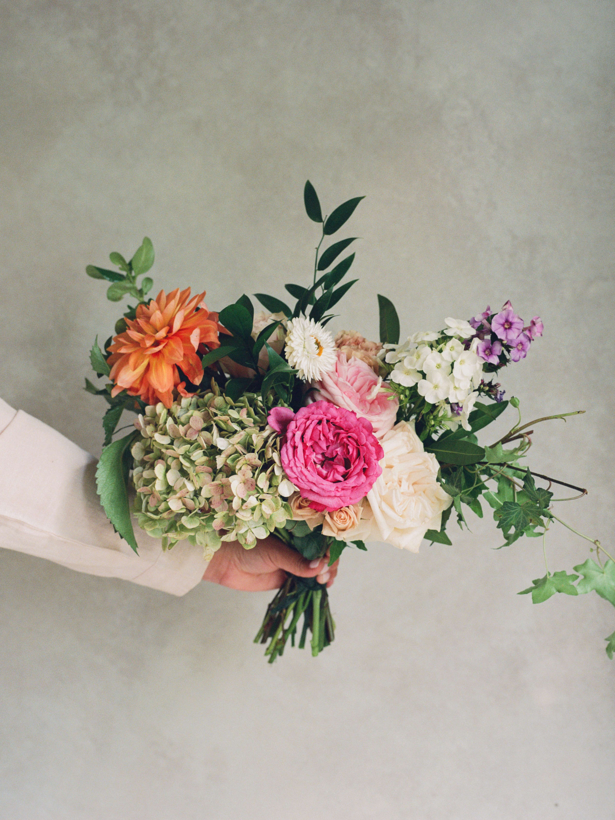 Flower House Seasonal Wrapped Bouquet  - All of our favorite blooms of the day bundled into a lovely bunch!  We will use the freshest flowers and greenery and wrap them up. Each week will be a different mix.   Place Bouquet in a Vase as soon as possible and fill the vase up to the top. Change water every 2-3 days, and trim the stems on an angle every 2-3 days. Keep away from strong heat sources such as electrical appliances and direct sunlight, also don’t keep the arrangement under an air-conditioner.