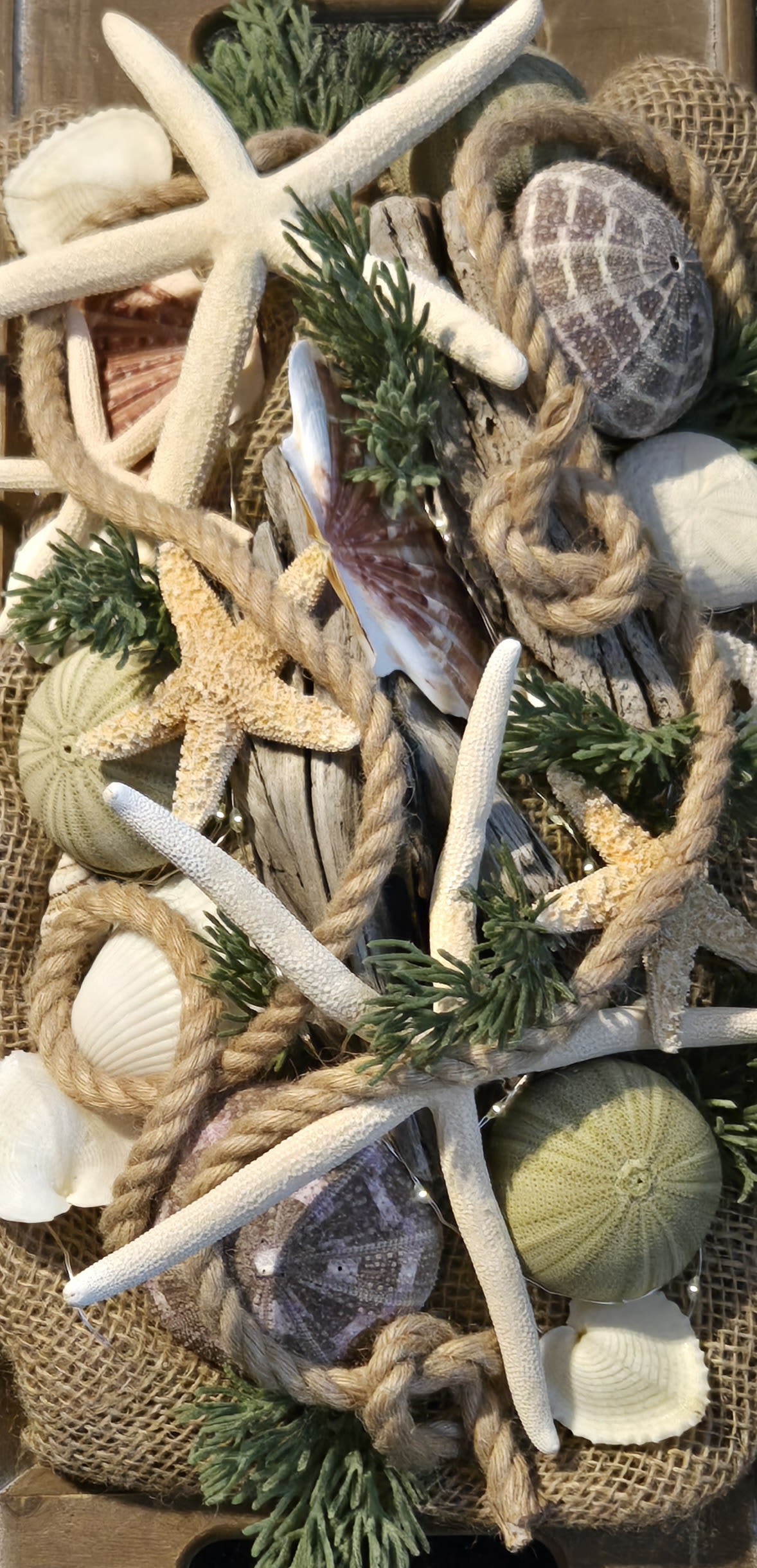Manchester-By-The Sea  - This grand seascape centerpiece was custom designed, &quot;one-of-a-kind&quot;. Beautifully appointed details throughout the seascape of burlap, roping, seashells, starfish, faux botanicals, sand dollars and more! The driftwood ties in with the quality, long &amp; low, earthy wooden vessel. Truly unique! Even has a string of fairy stars, twinkling lights within the scape. A battery pack tucked underneath the burlap. Soooooo enchanting on a dinning room table or kitchen Island, mantel, buffet or sideboard. Maybe a conference room, office or lobby even. Indoor centerpiece to avoid direct sun, moisture or extreme temperatures. No watering needed! 