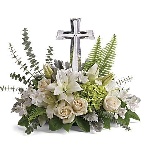 Life's Glory Bouquet by Teleflora - This peaceful bouquet of soft white flowers and green accents is a beautiful message of sympathy, adorned with a large crystal cross keepsake.  Green hydrangea, crème roses, white asiatic lilies, and white alstroemeria are accented with dusty miller, sword fern, spiral eucalyptus, and lemon leaf. Delivered with a Large Crystal Cross Keepsake. Approximately 22 1/2&quot; W x 18&quot; H