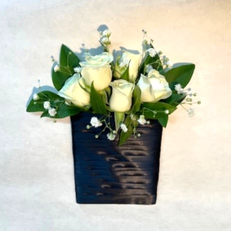 Boutonniere - Pocket  - Add a modern twist to your formal attire with our Pocket Boutonniere, a sleek and stylish accessory designed to fit perfectly into your suit or tuxedo pocket. Featuring delicate white spray roses and fresh natural greenery, this boutonniere offers a timeless and elegant look for weddings, proms, homecoming dances, or other formal celebrations. For those looking to personalize their boutonniere, upgrades include seasonal flowers such as calla lilies, ranunculus, anemones, hydrangeas, and stock blossoms for a more luxurious touch. DELUXE version shown. Key Features: -White Spray Roses: Petite and elegant blooms that add a classic and sophisticated touch. **Natural Greenery: A lush mix of foliage for a fresh and organic aesthetic. **Pocket-Style Design: Sleek and secure, designed to slide effortlessly into your jacket pocket without the need for pins. **Seasonal Flower Upgrades: Add premium blooms like calla lilies, ranunculus, anemones, hydrangeas, or stock blossoms for a customized and elevated look. -Benefits: **A modern alternative to traditional pinned boutonnieres, ensuring no damage to your attire. **Versatile design complements a variety of formalwear styles and event themes. Whether you prefer a minimalist look or a statement-making design, the Pocket Boutonniere offers the perfect balance of style and sophistication. Order now for a boutonniere that’s as unique and memorable as the occasion itself!