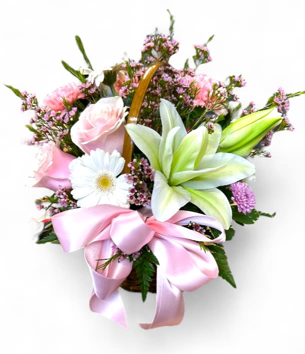 Luxe Love Basket Luxe Love Basket - A beautiful, delicate flower basket, perfect to bright their day. The basket is filled with a mix of pink and white flowers, including roses, lilies, and daisies, accented with touches of greenery. A soft pink satin ribbon is elegantly tied around the basket, adding a touch of sweetness and femininity to this lovely gift. This bouquet is a thoughtful and lovely way to express your appreciation and love.
