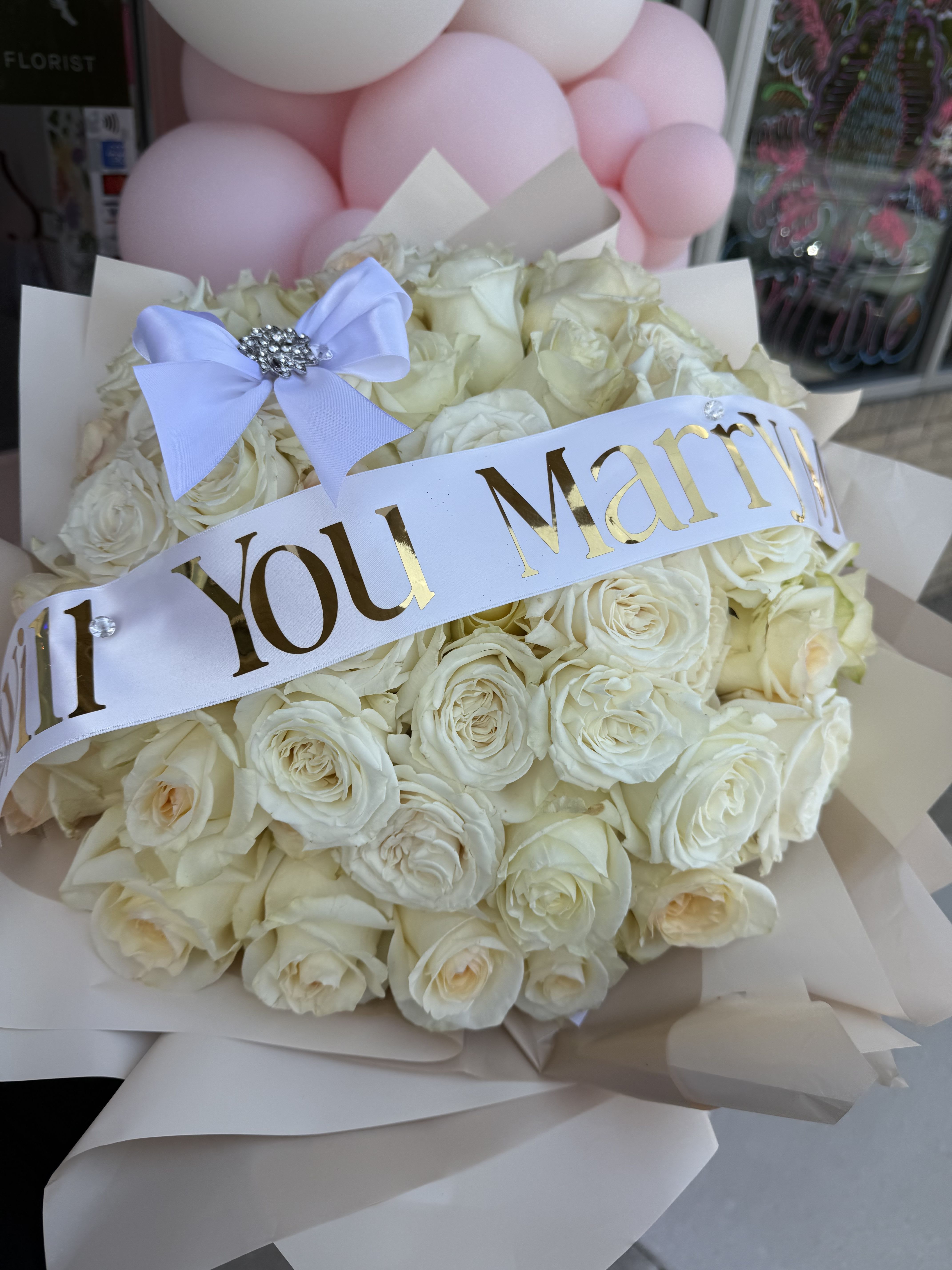 Will You Marry Me? Will You Marry Me? - 50 white roses arranged as a ramo buchon. You are able to customize the ribbon.
