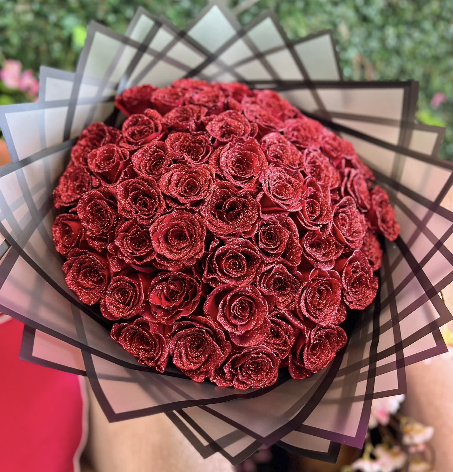 Red Rose Glitter Bouquet  - Glitter red rose bouquet is a captivating arrangement designed to exude romance and elegance with a touch of glamour. The bouquet features lush, deep red roses with their petals delicately dusted in shimmering glitter, catching the light with every angle.  STANDARD 24 ROSES DELUXE 36 ROSES PREMIUM 50 ROSES