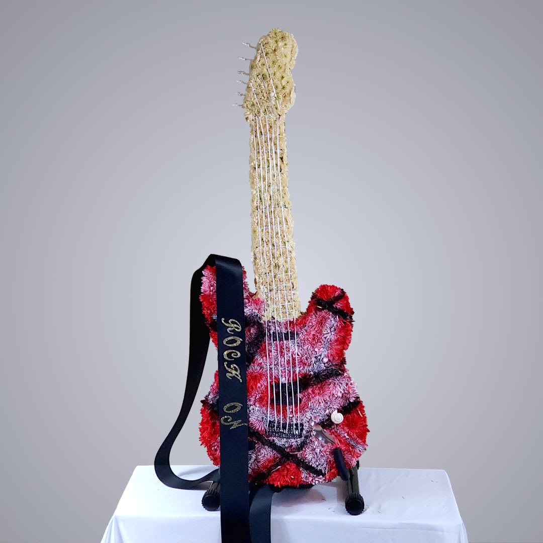Rock On Rock On - Floral guitar based on Eddie Van Halen's trademark Frankenstein, or "Frankenstrat" guitar, version 2. Built to actual size, includes everything pictured, including strap and guitar stand. Do you have a guitar hero? We can custom build a fresh floral masterpiece to your specifications.