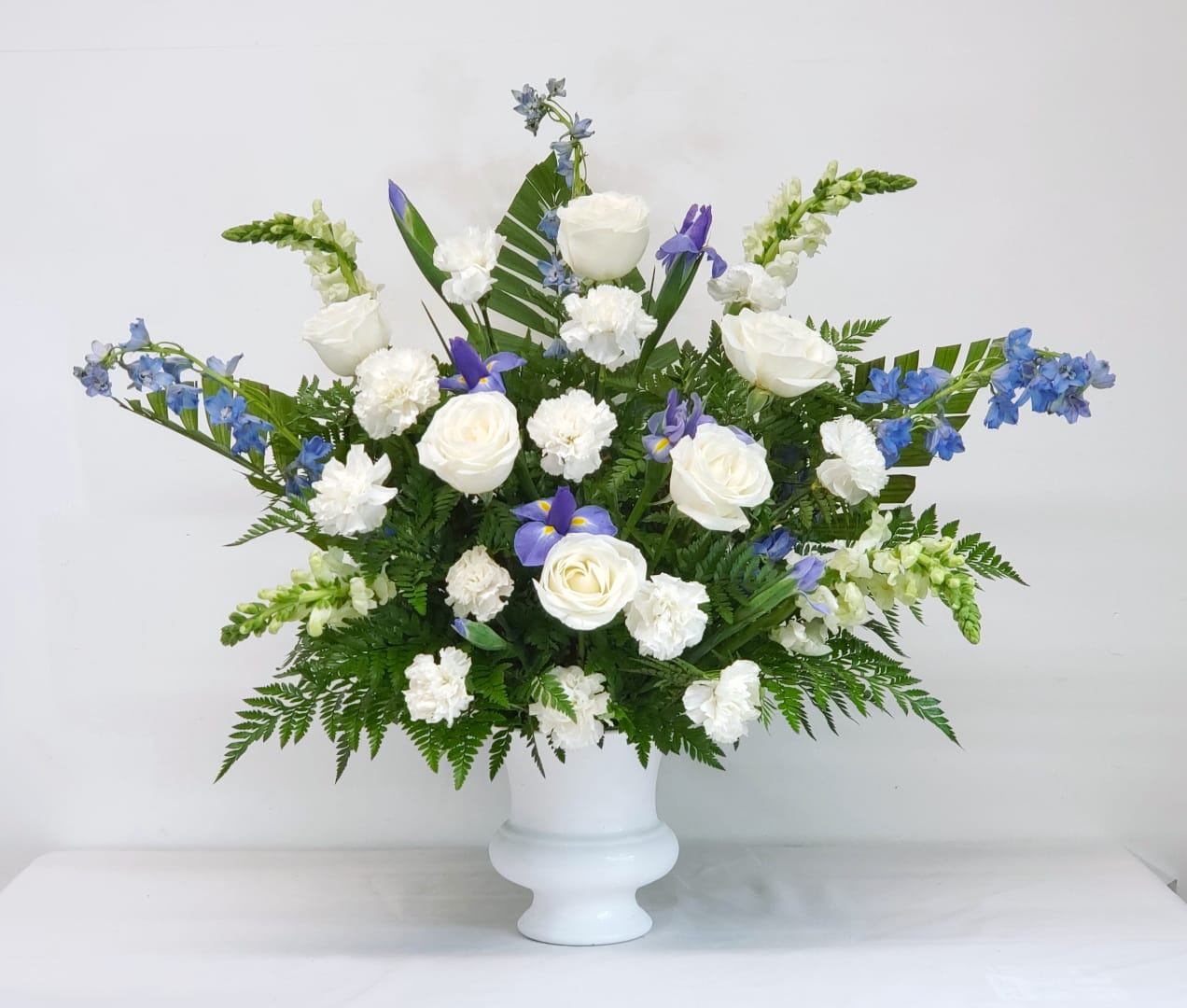 Iris Fields Iris Fields - Serene, calming pedestal arrangement for the service. Approximately 36" wide by 32" tall.